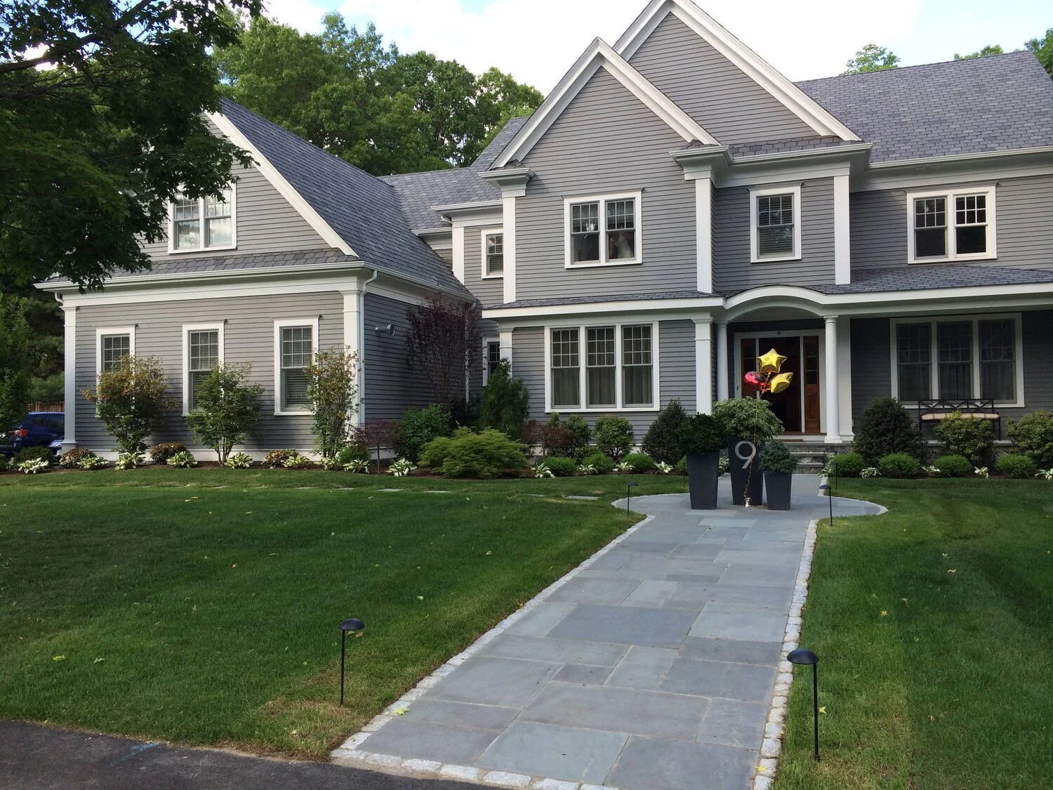 Home exterior with garden path and outdoor lighting in Arlington, MA