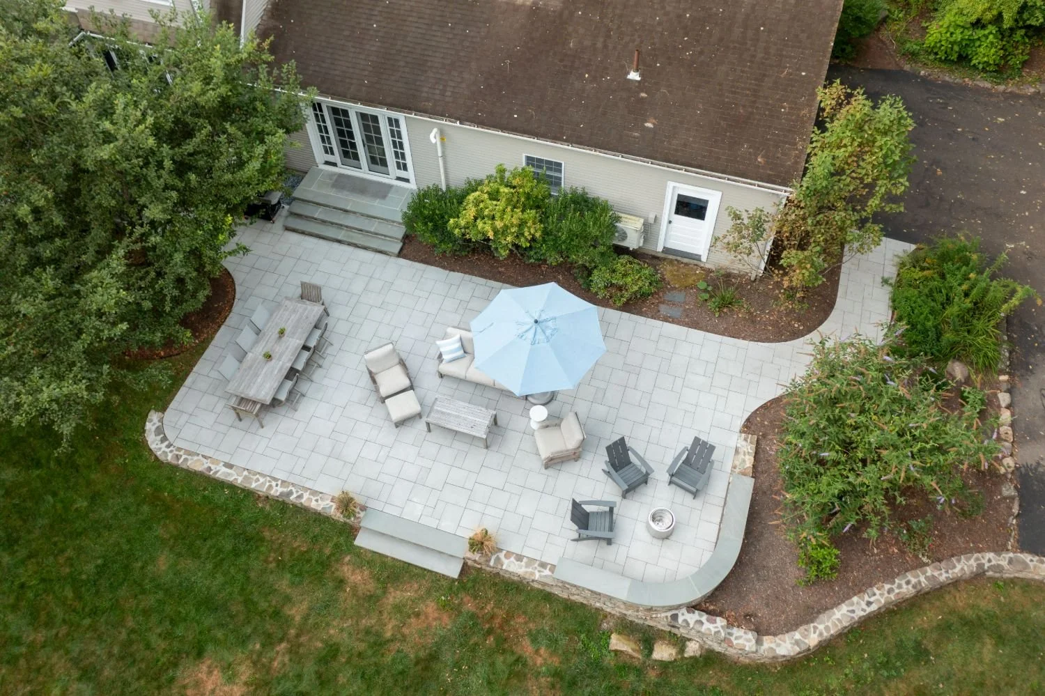 Integrated patio lighting illuminating outdoor seating areas in Lexington, MA