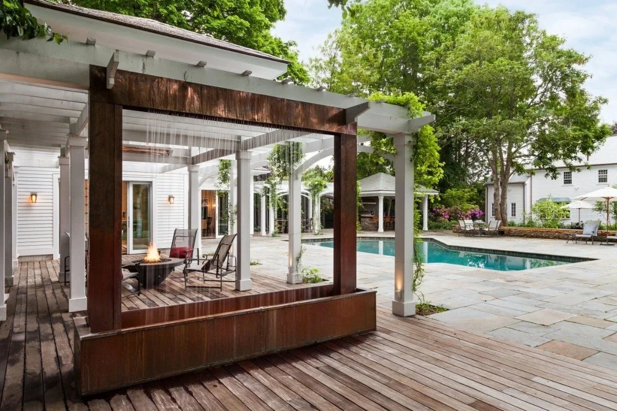 Rainfall water feature with wood backdrop on pool deck in Cambridge, MA