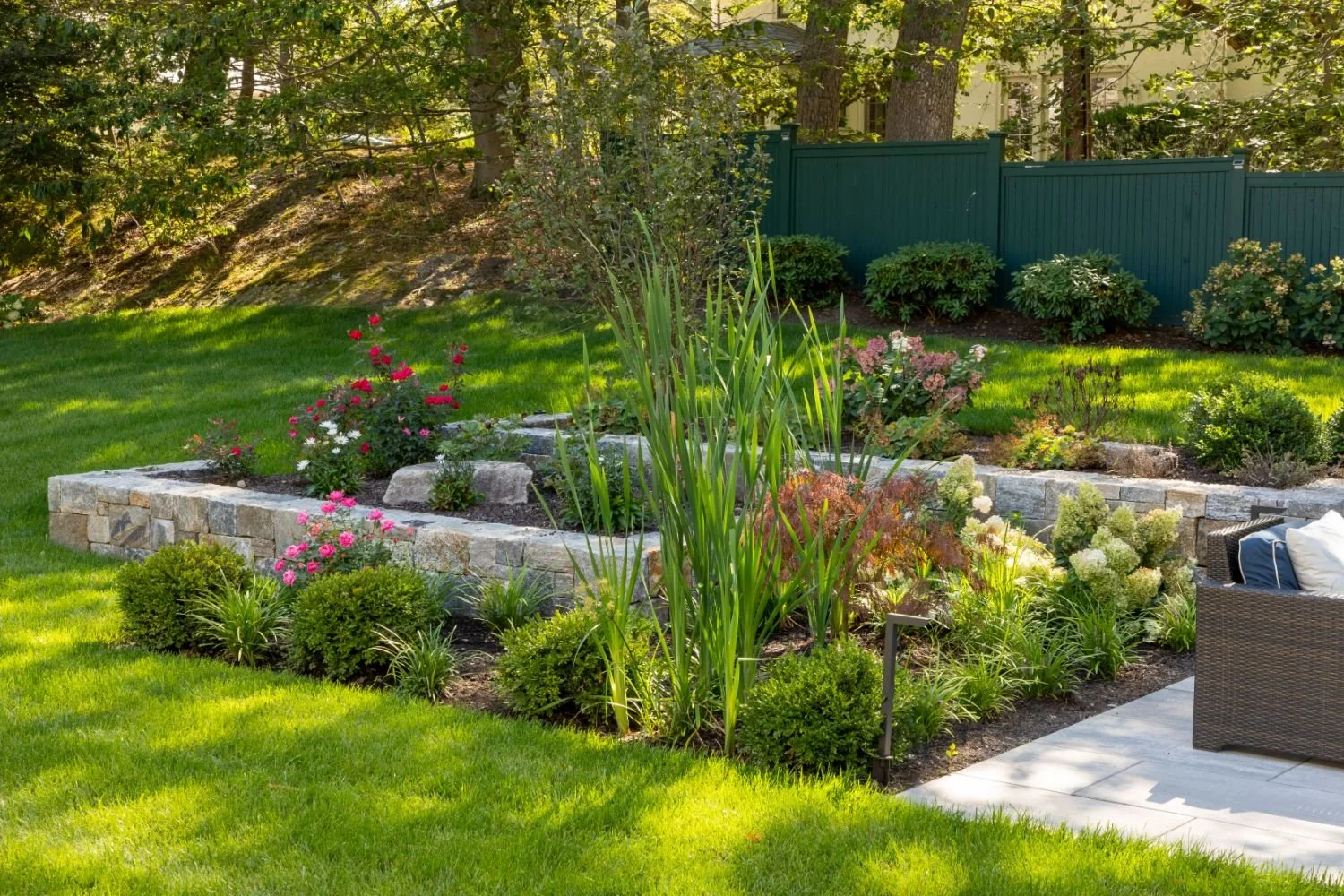 Landscape design with stone retaining walls and plantings in Arlington, MA