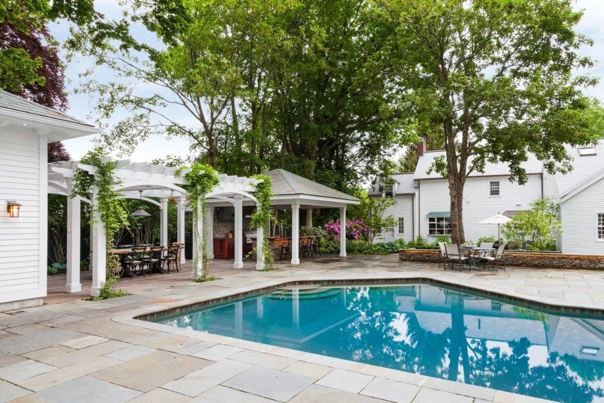 Modern pool deck with pergola and outdoor seating in Cambridge, MA