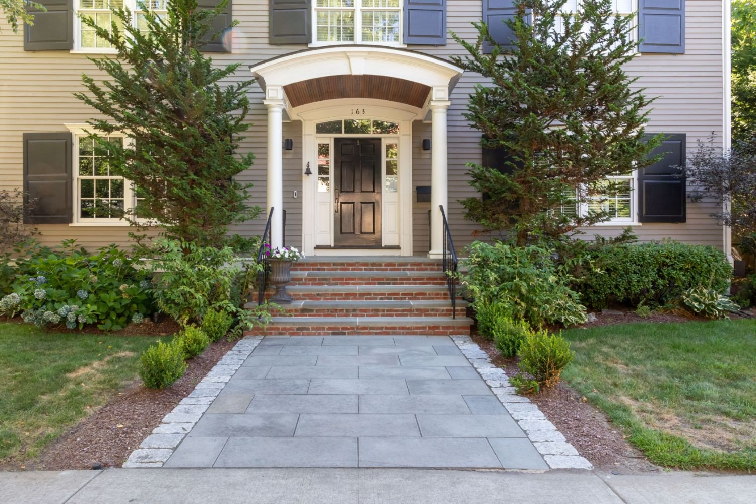 Reimagined front entry with patio pavers by premier pavers & hardscape co in Arlington, MA
