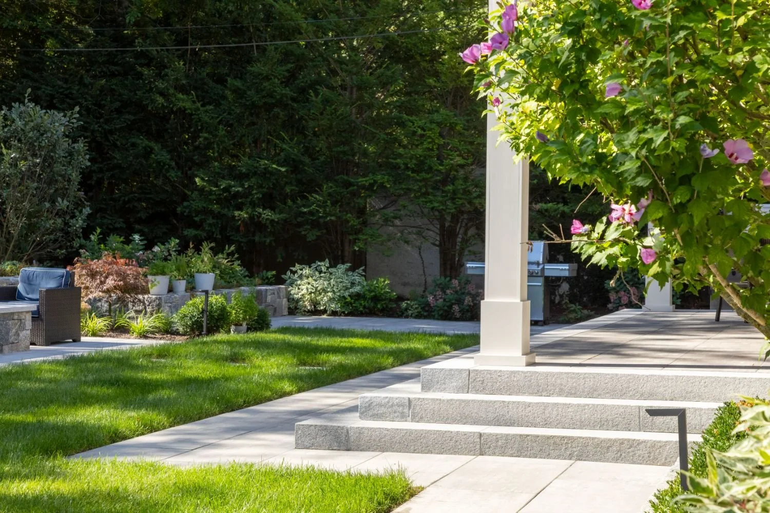 Patio pavers and walkway framing a covered porch in Arlington, MA