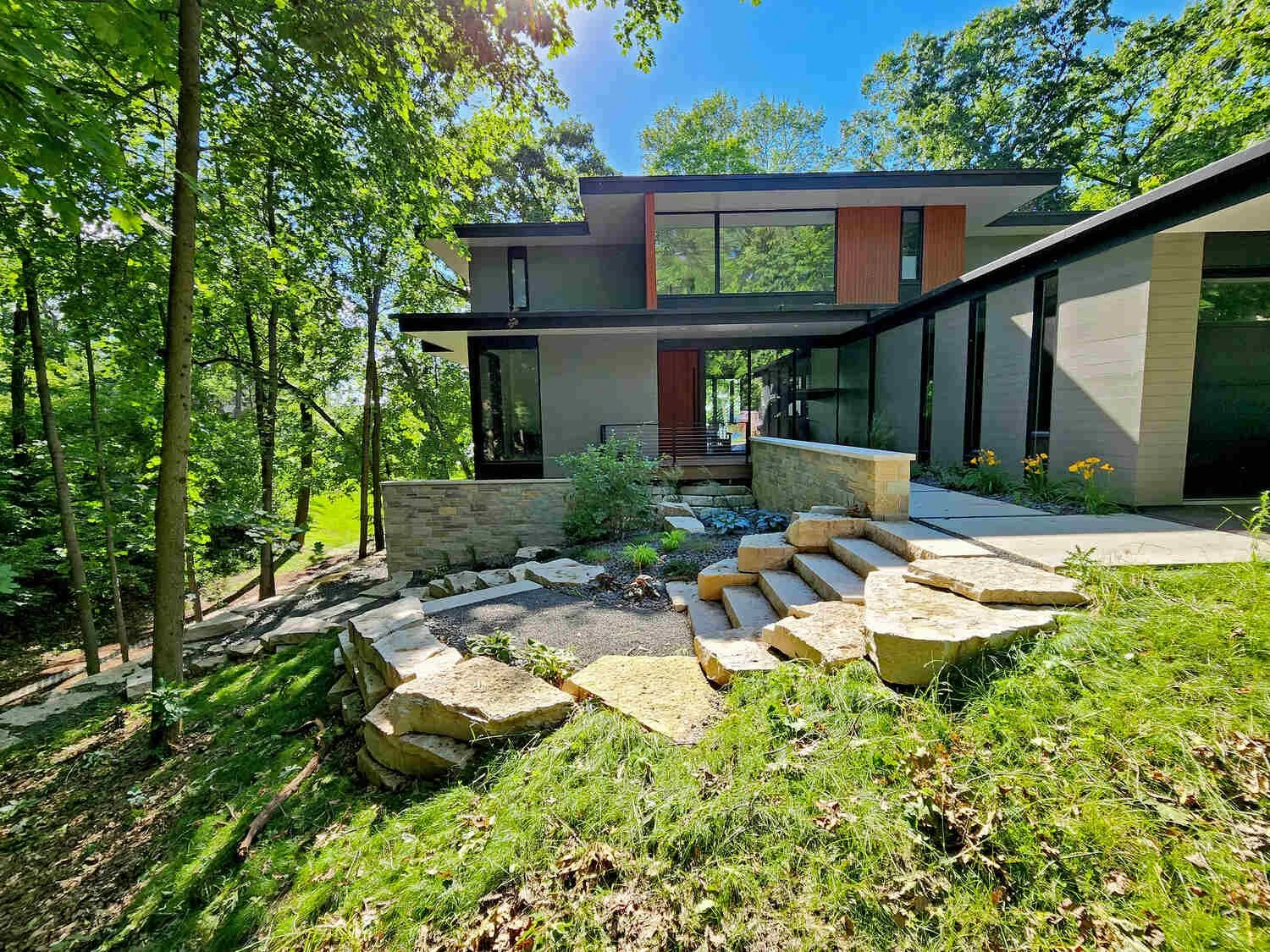 Hillside landscape transformation with natural materials in Madison, WI