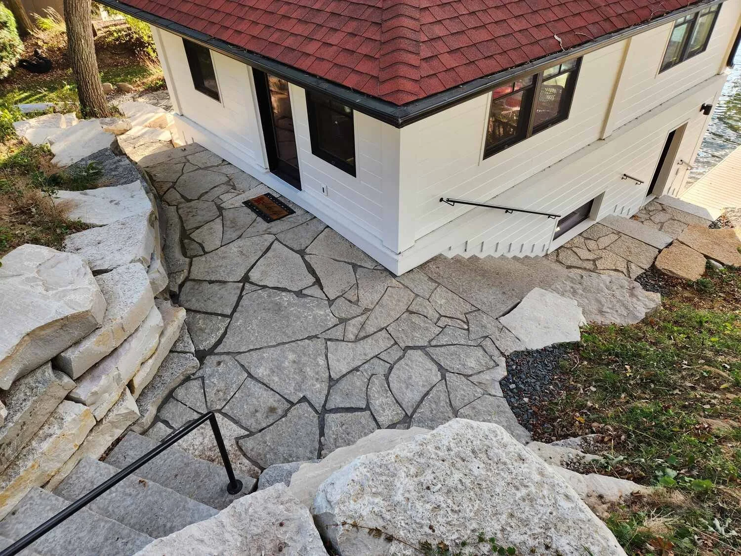 Broad stone steps descending hillside toward boathouse in Verona, W
