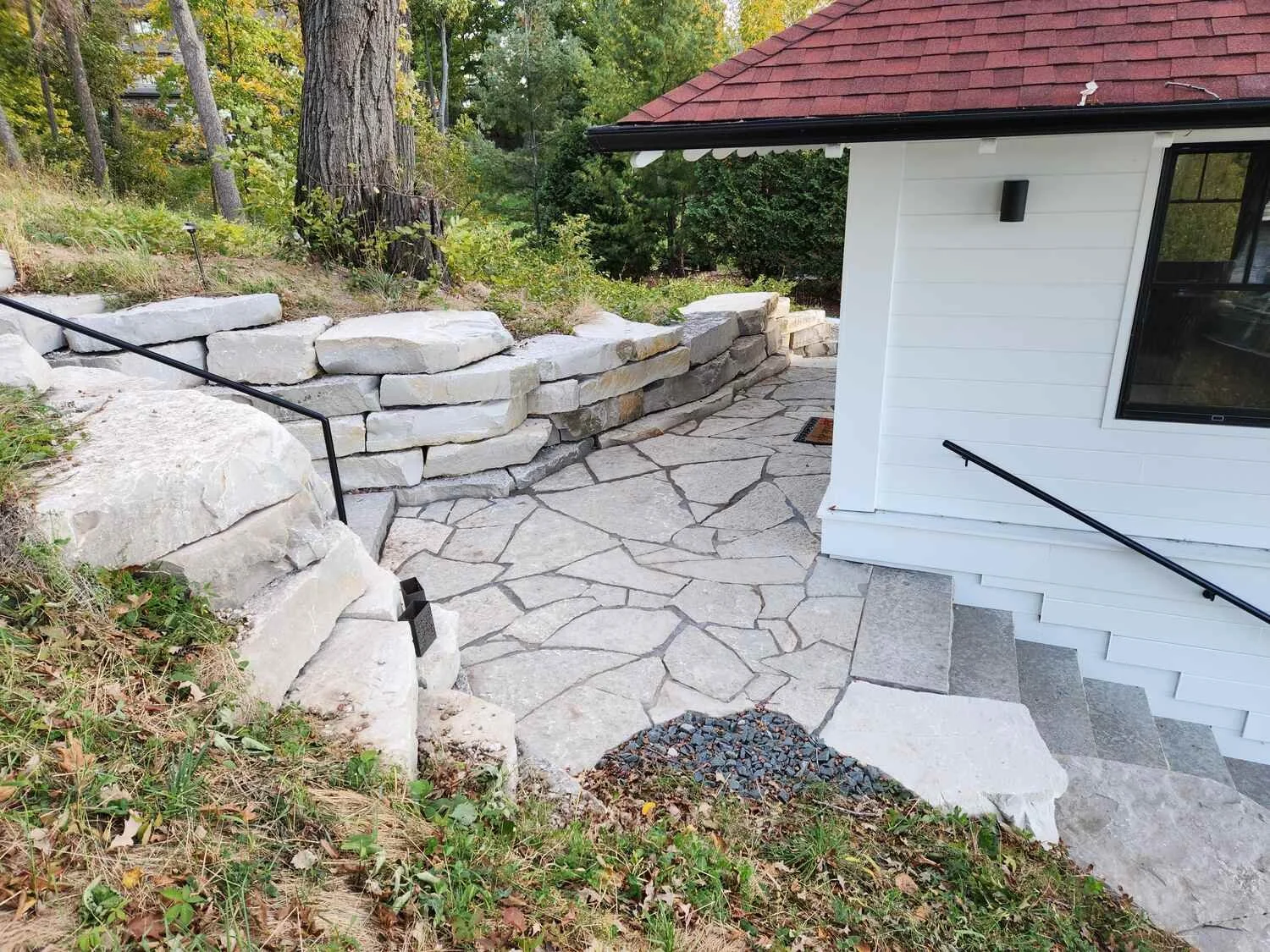 Natural stone retaining wall built into steep slope in Madison, WI