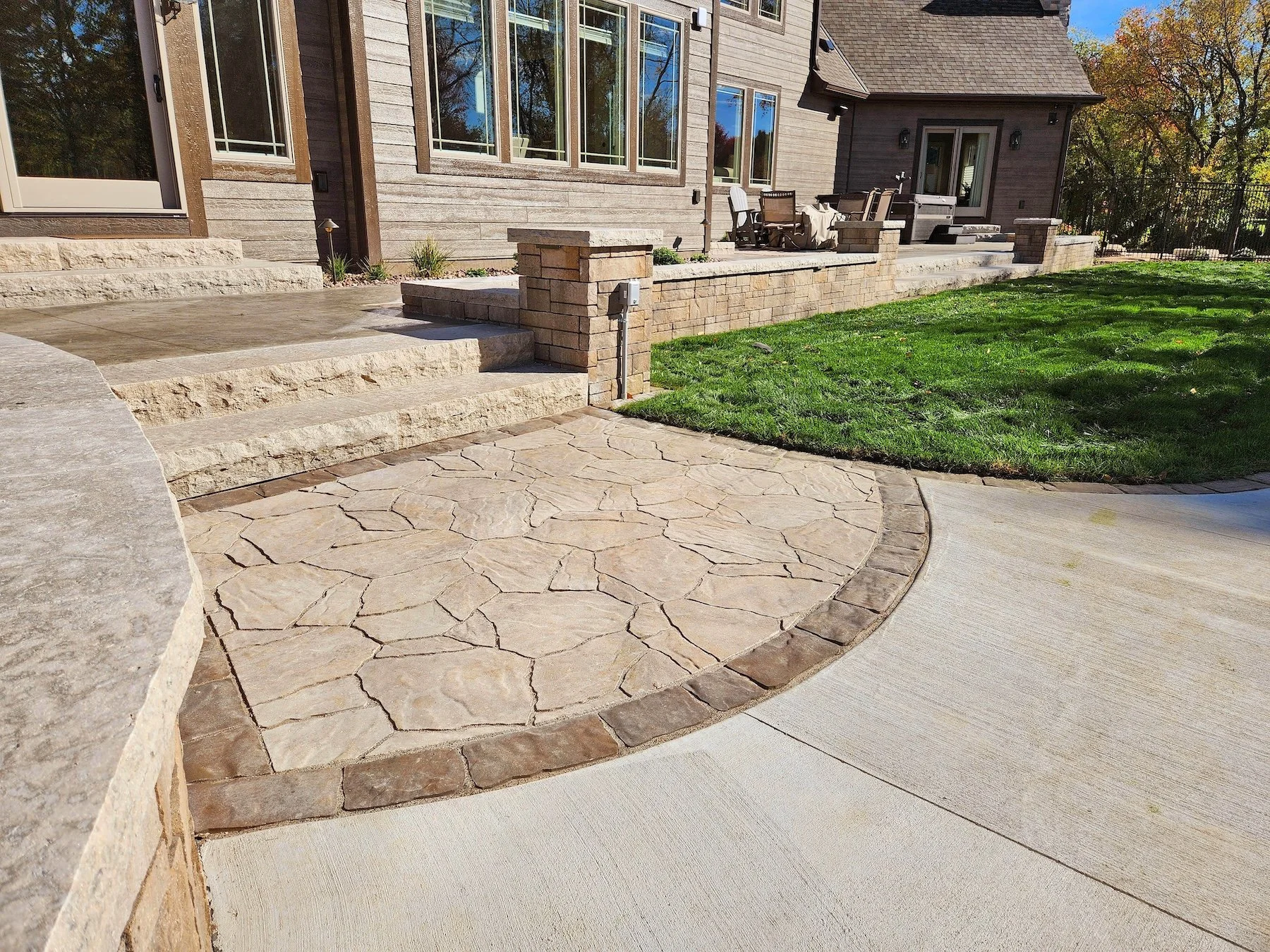 Backyard oasis featuring paver patio and outdoor kitchen in Sun Prairie, WI