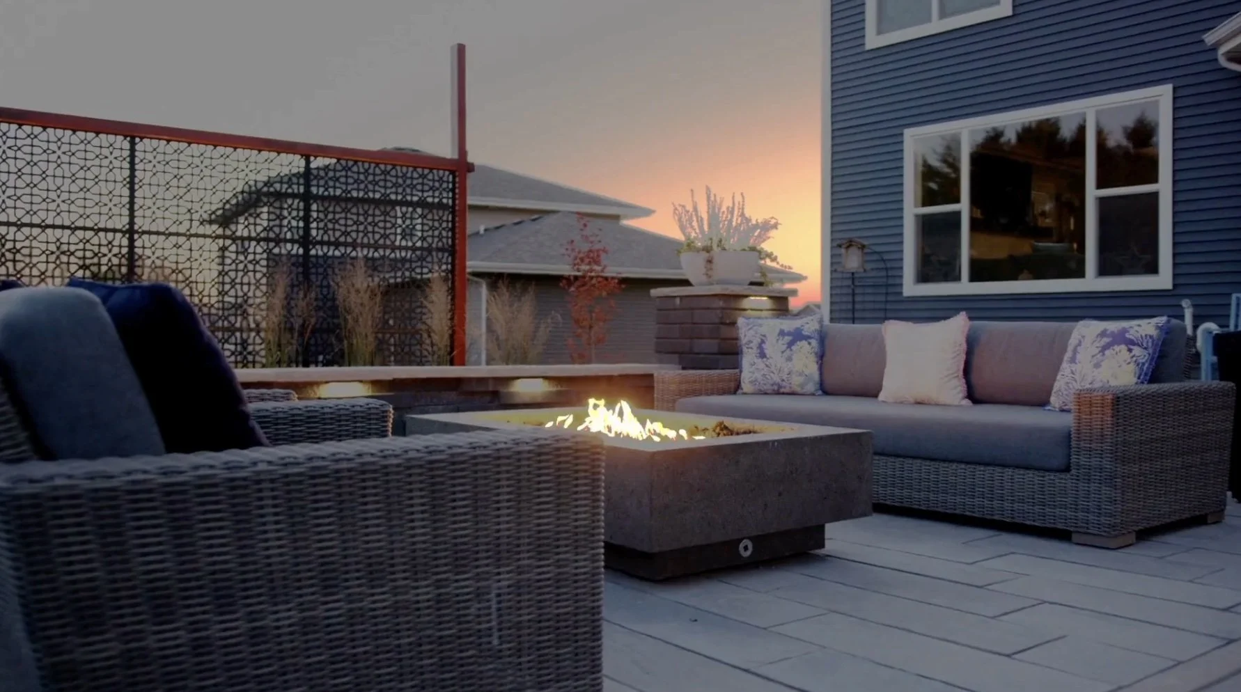 Modern patio with fire pit and outdoor seating at sunset in Fitchburg, WI.jpg