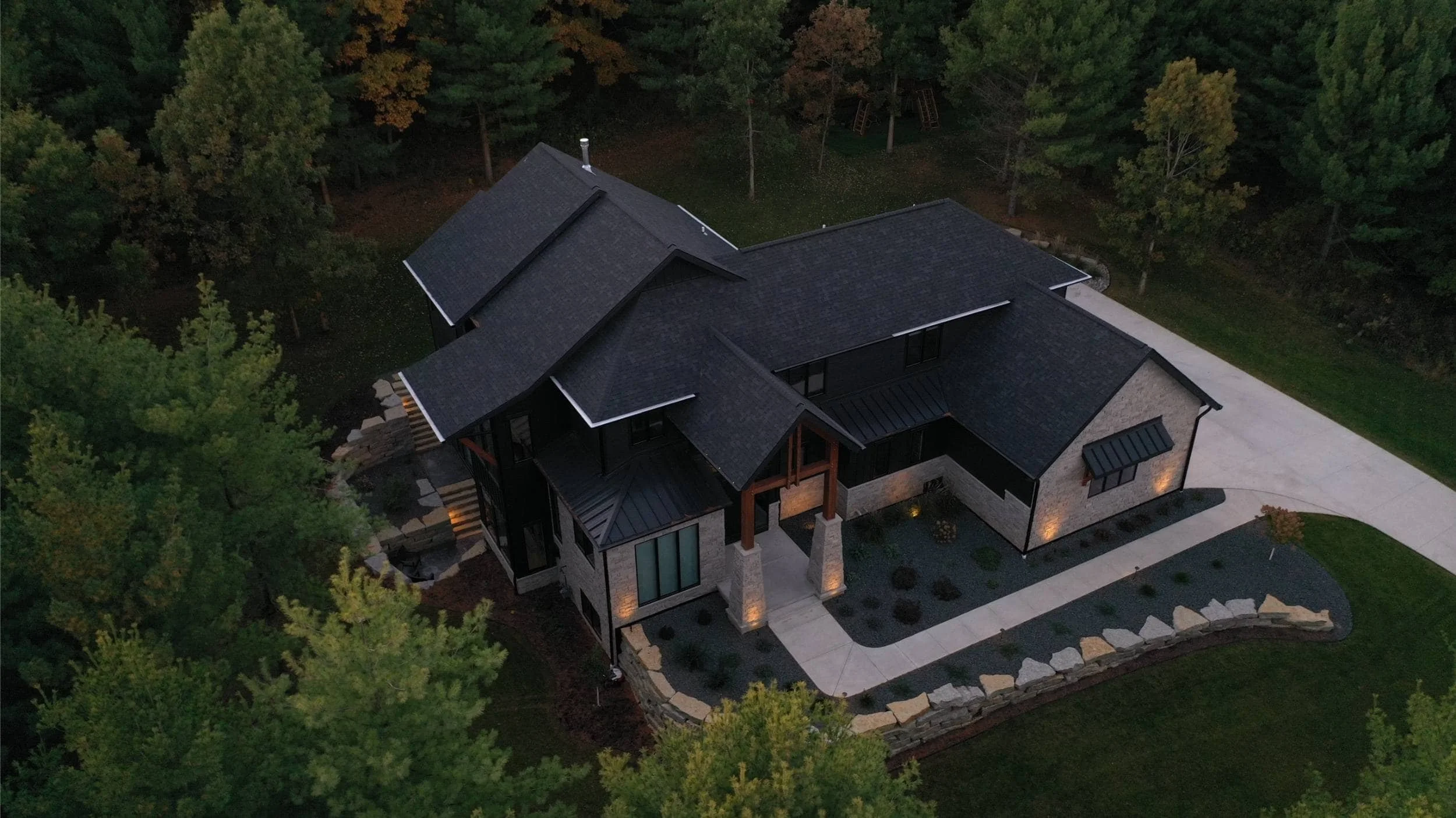 Front yard landscape design with mulch beds, stone edging, and walkway in Waunakee, WI
