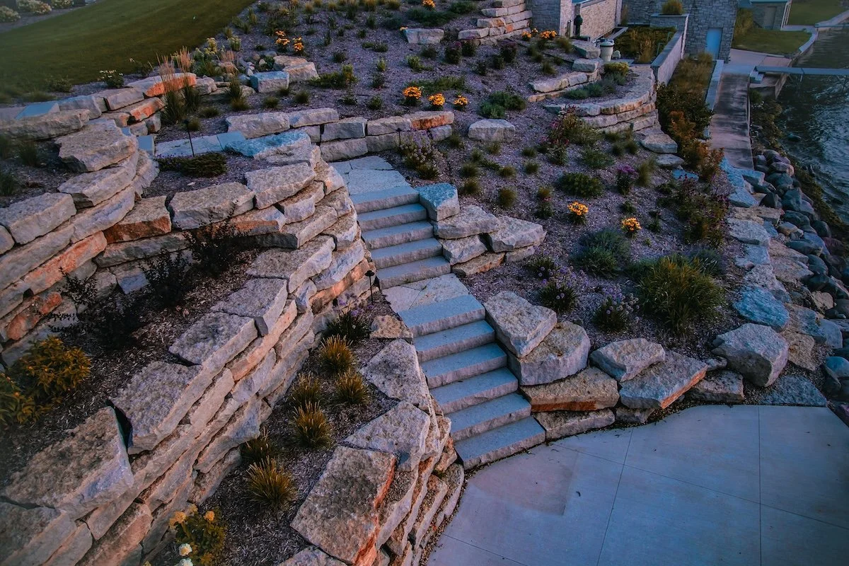 Front yard landscape design with mulch beds, stone edging, and walkway in Waunakee, WI