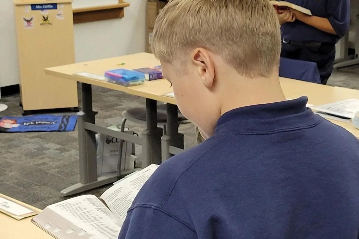 Children engaging in art activities with painting supplies in a classroom setting.