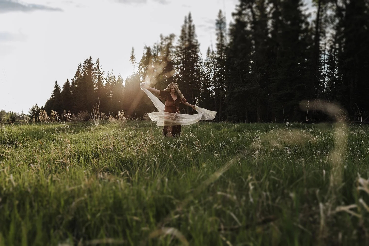 A woman playing in field for a branding session.