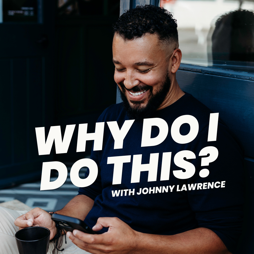 A man with curly hair and a beard smiling while looking at his phone, sitting outdoors near a window, with text overlay that says 'Why Do I Do This? with Johnny Lawrence'.
