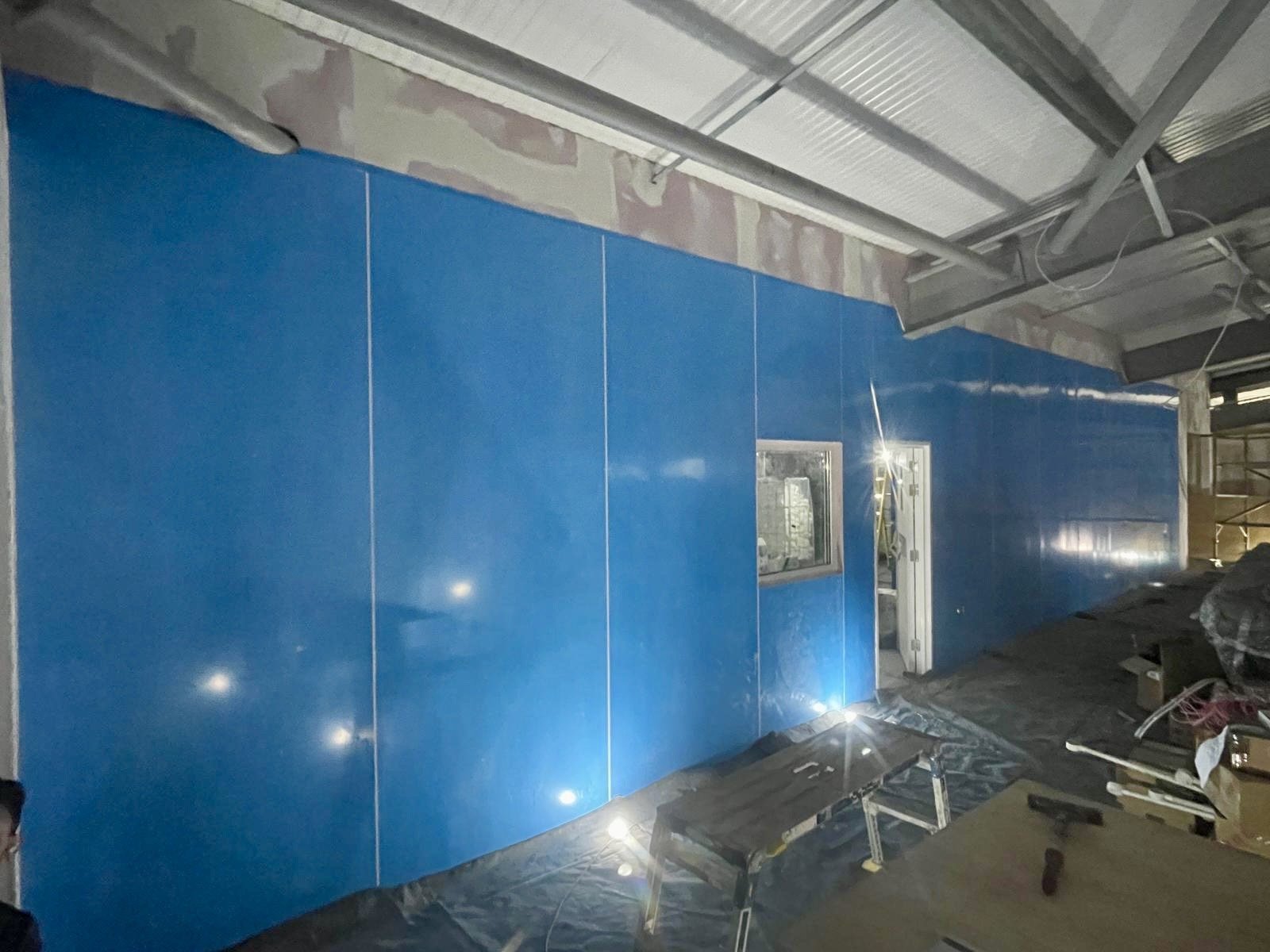 Installation of moisture and heat resistant wall cladding, at Faversham Linen Services in Kent, installed by Cladify.