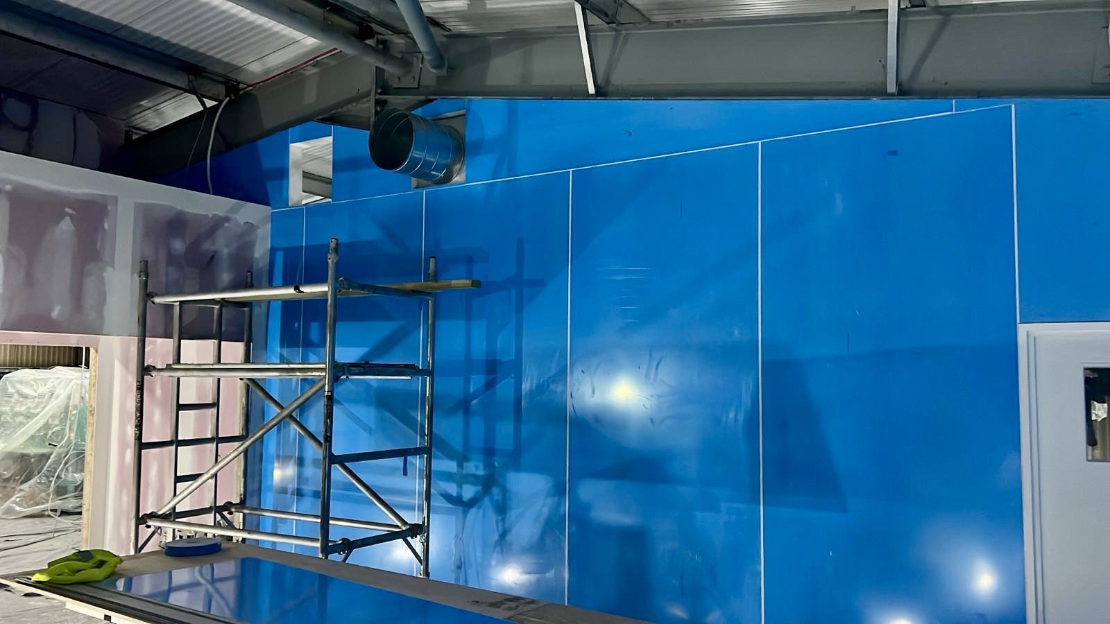 Installation of moisture and heat resistant wall cladding, at Faversham Linen Services in Kent, installed by Cladify.