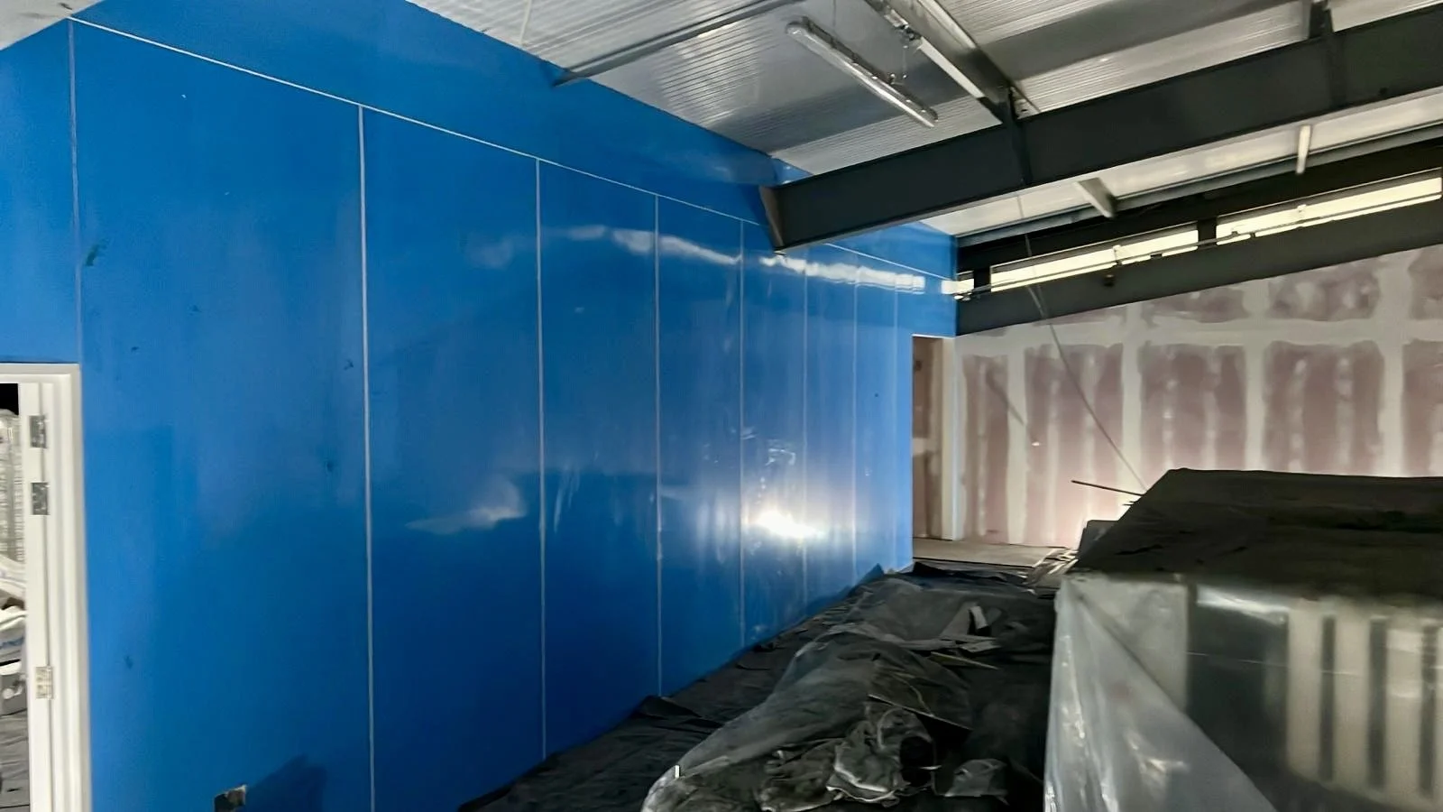 Installation of moisture and heat resistant wall cladding, at Faversham Linen Services in Kent, installed by Cladify.