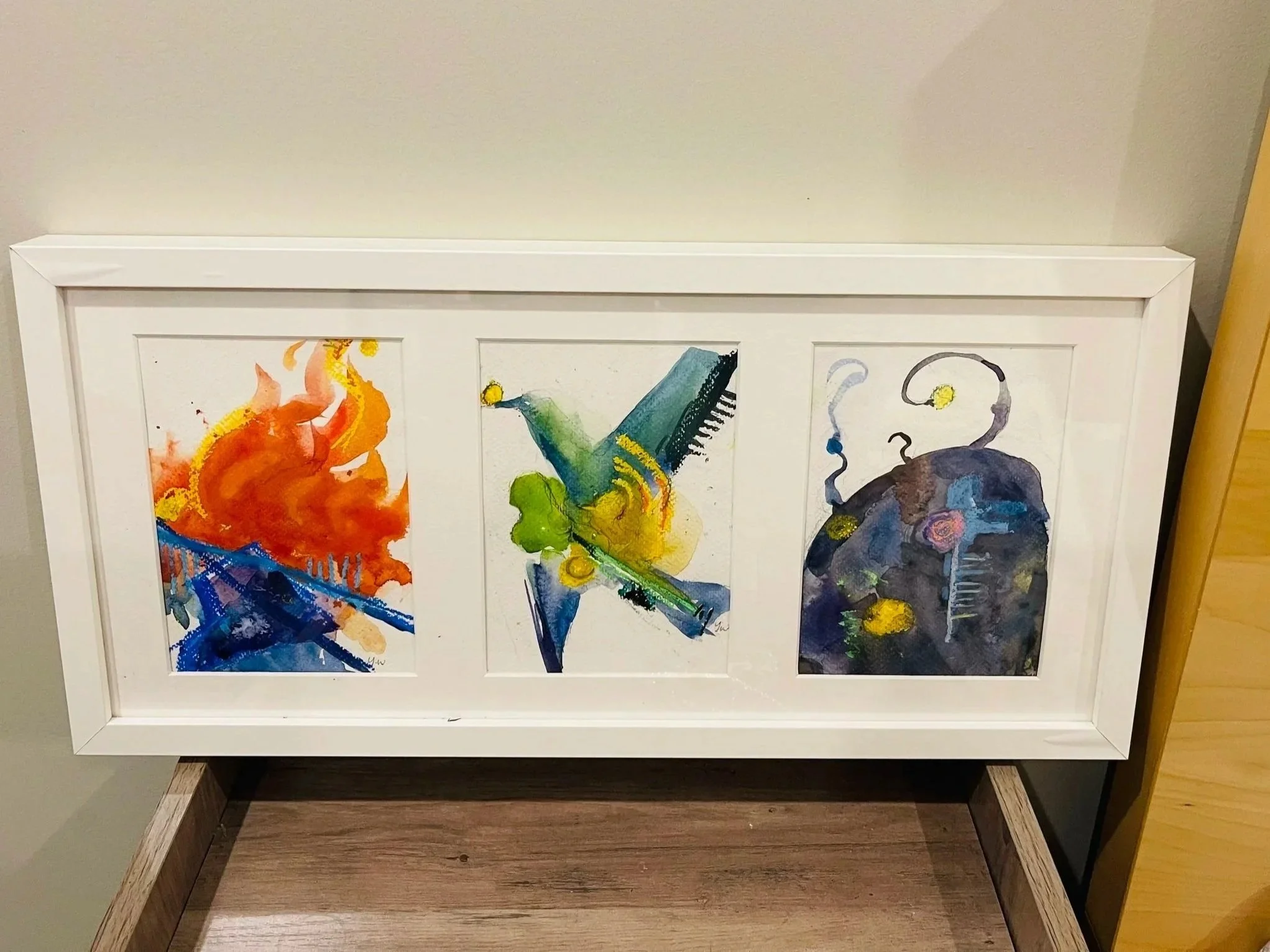 Custom framed watercolor triptych with abstract personal illustrations