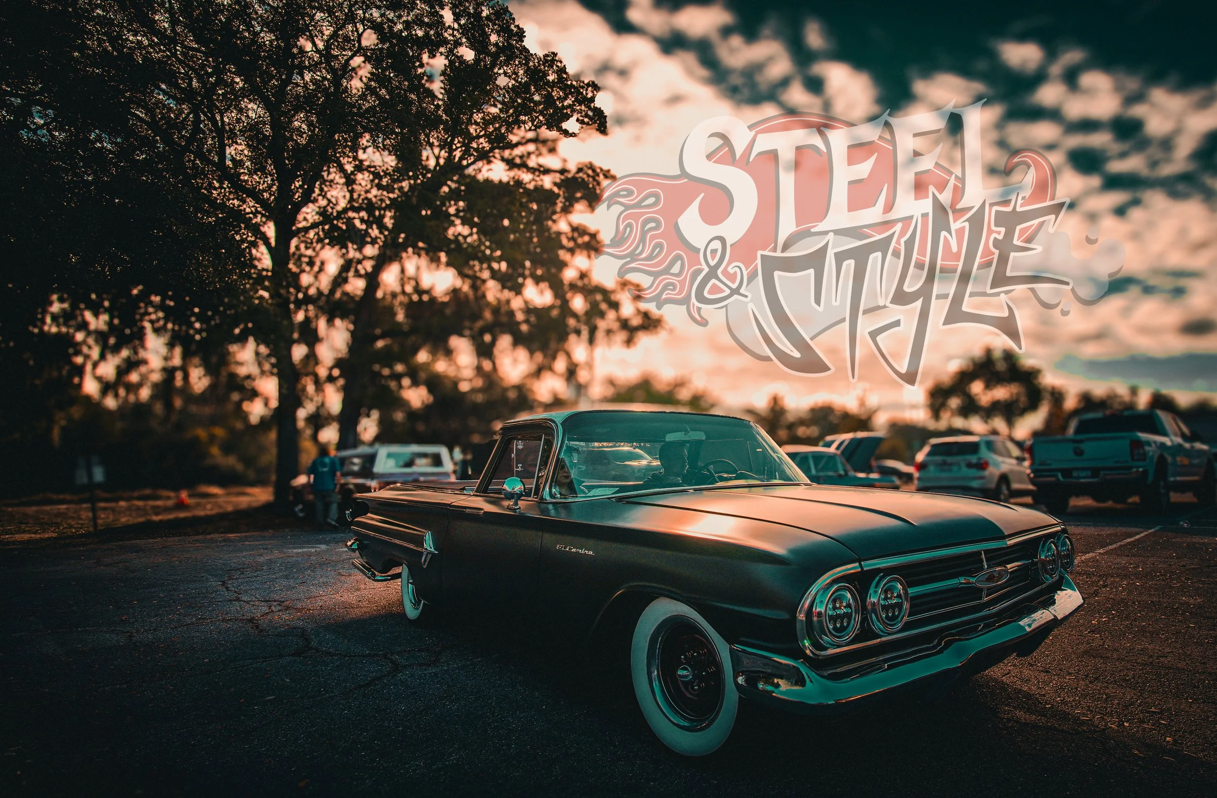 A vintage black car parked in a lot during sunset, with a large tree and a group of cars in the background. Overlaid text reads 'Steel & Chrome' in stylized font.