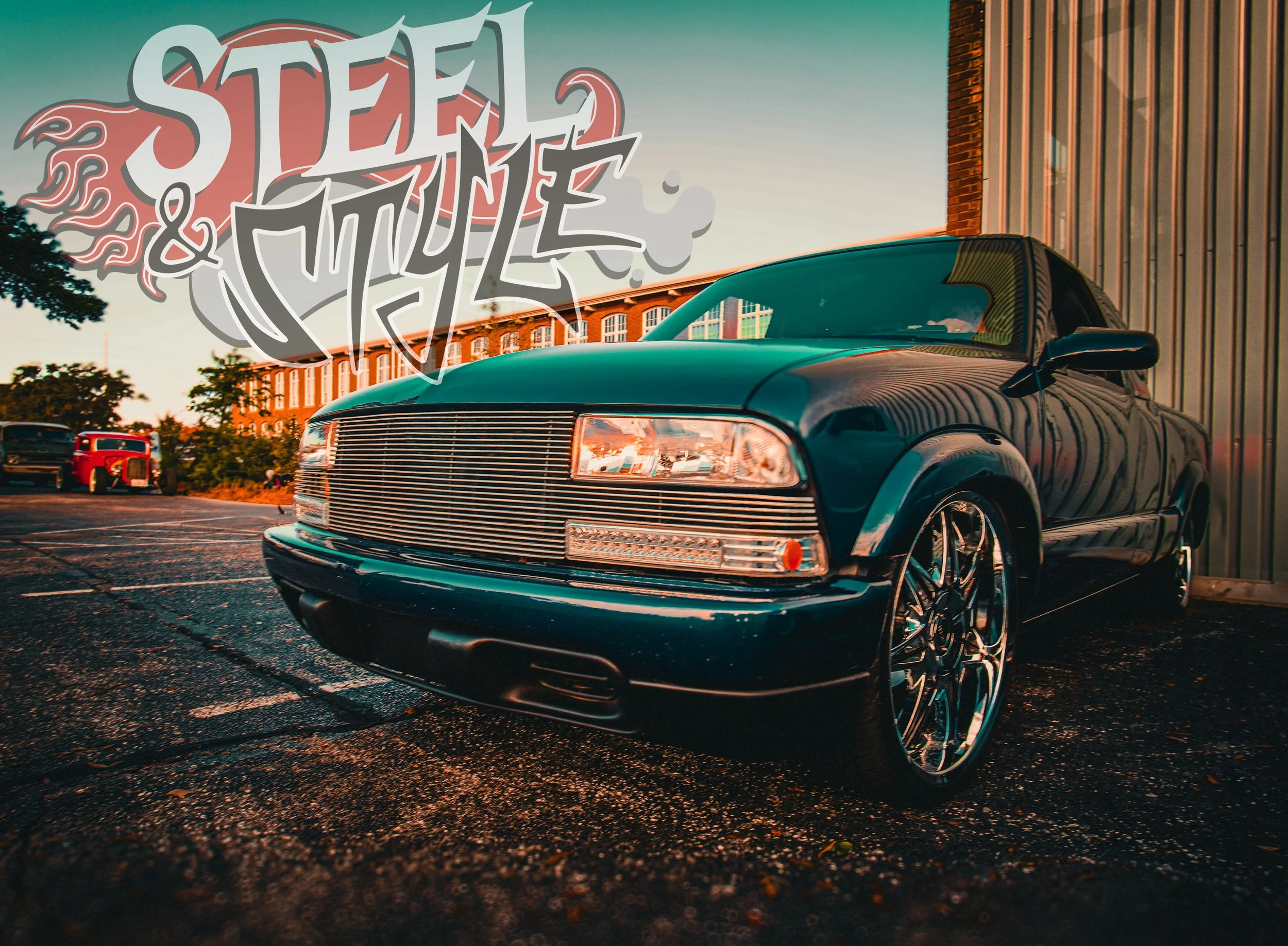 A dark green vintage car with shiny rims parked on a paved lot, with a building and trees in the background during sunset. A graffiti-style text saying 'STEEL & STYLE' is overlaid on the top left of the image.