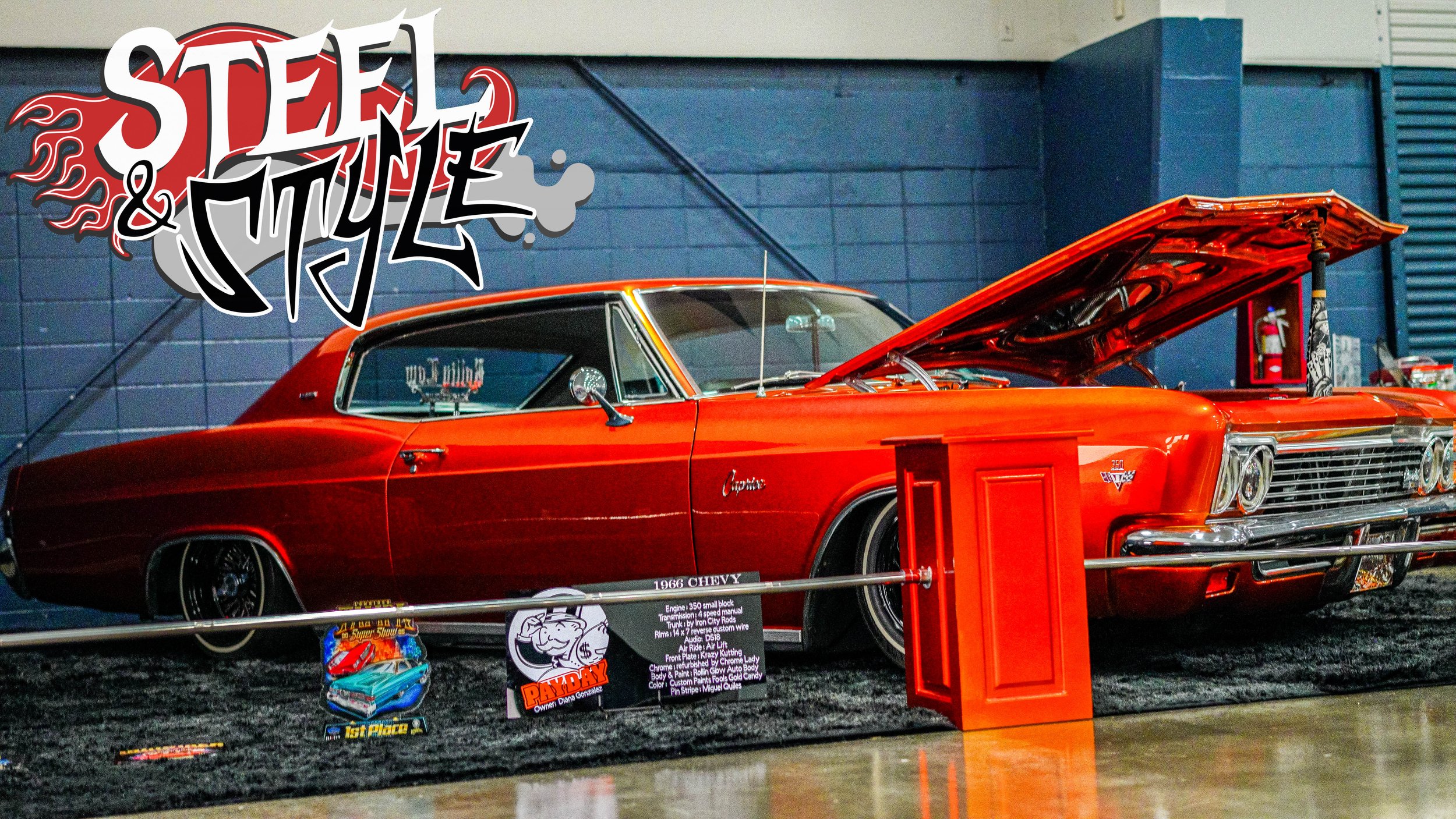 Red 1966 Chevrolet Chevelle under a 'Steel & Style' banner, with an open hood showing the engine, displayed at a car show.