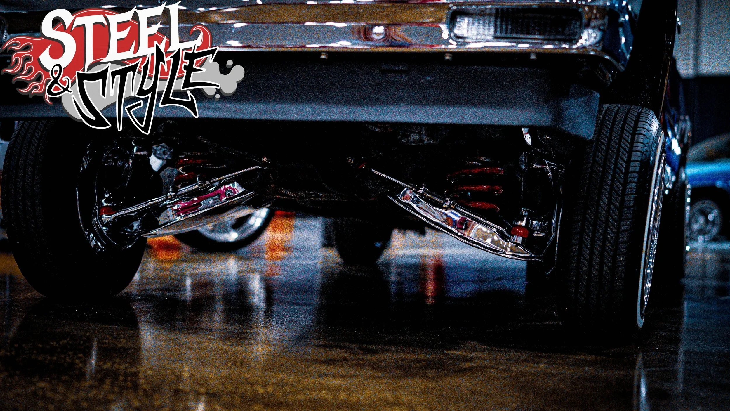 Low-angle view of the underside of a black vintage car showing chrome suspension components and tire, with a stylized "Steel & Style" graphic overlay.