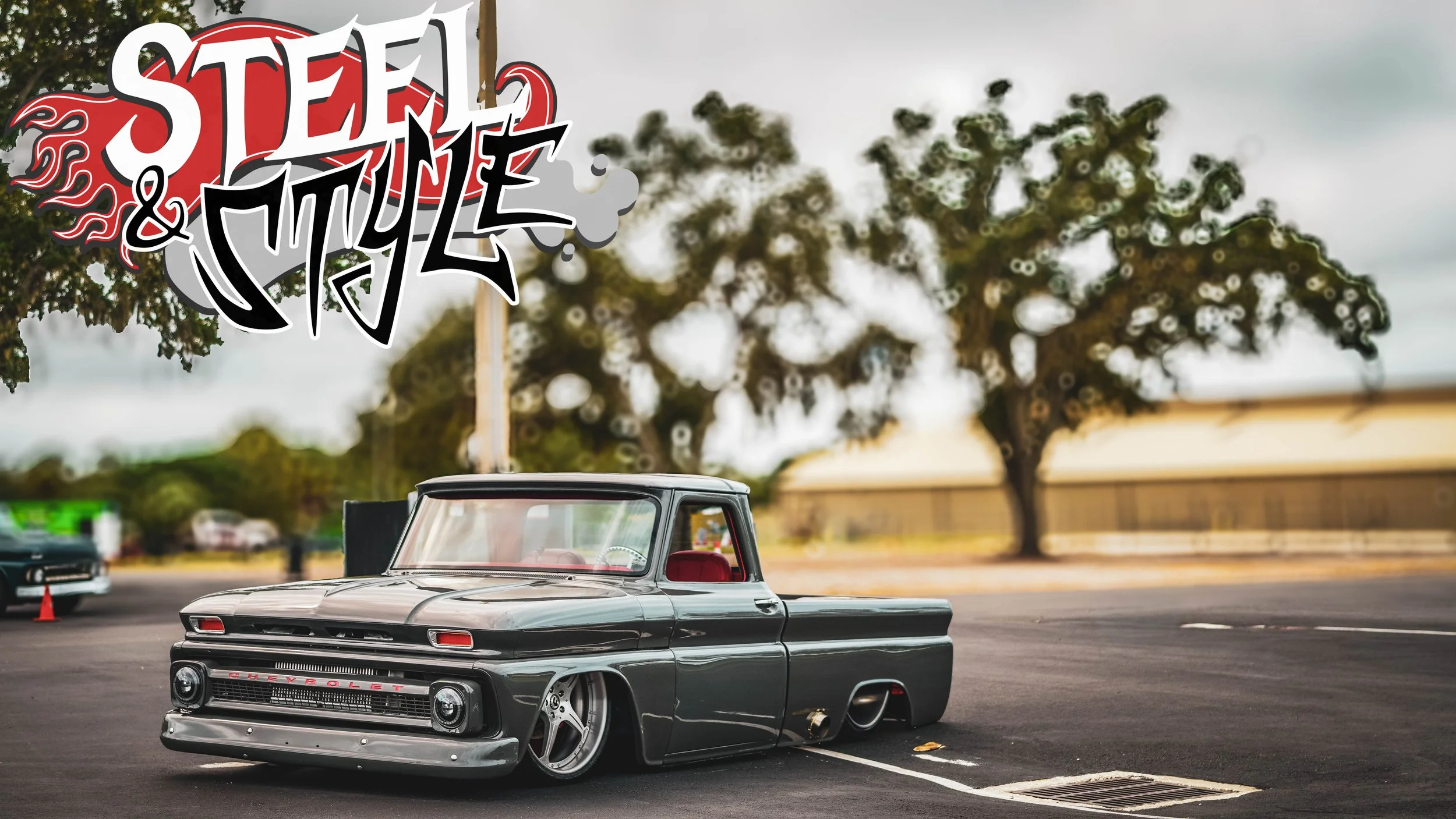 A miniature classic black Chevrolet truck with red interior parked in a parking lot with a large tree and cloudy sky in the background, overlaid with graffiti-style text 'Steel & Style'.