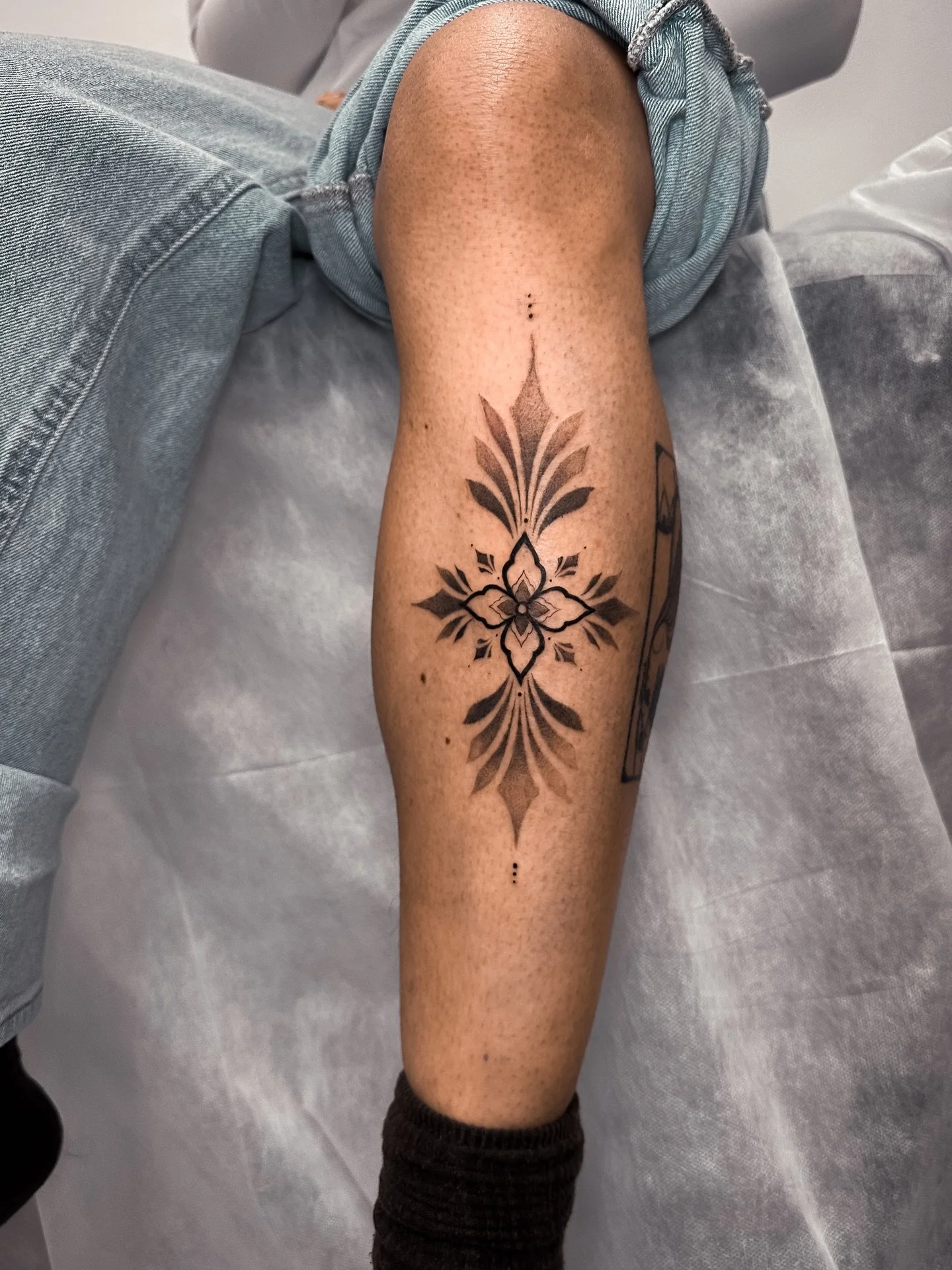 Ornamental flash tattoo on the shin