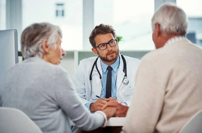 Doctor has conversation with two people
