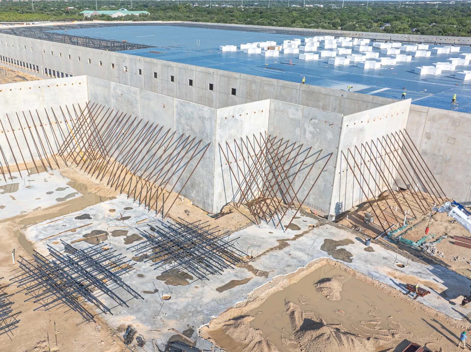 Drone aerial photo of large-scale tilt-up concrete warehouse construction progress at Nebraska Furniture Market in Texas