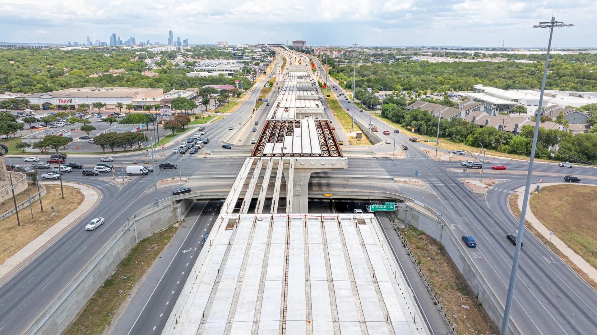 Drone aerial photo of elevated interstate bridge construction on I-35 in Austin, Texas, showing beams and roadway progress.