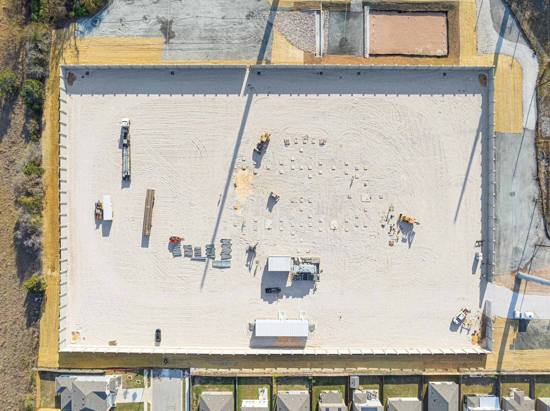 Drone progress photo of excavation and grading at an electrical substation site in Central Texas with gravel foundation and equipment staging.