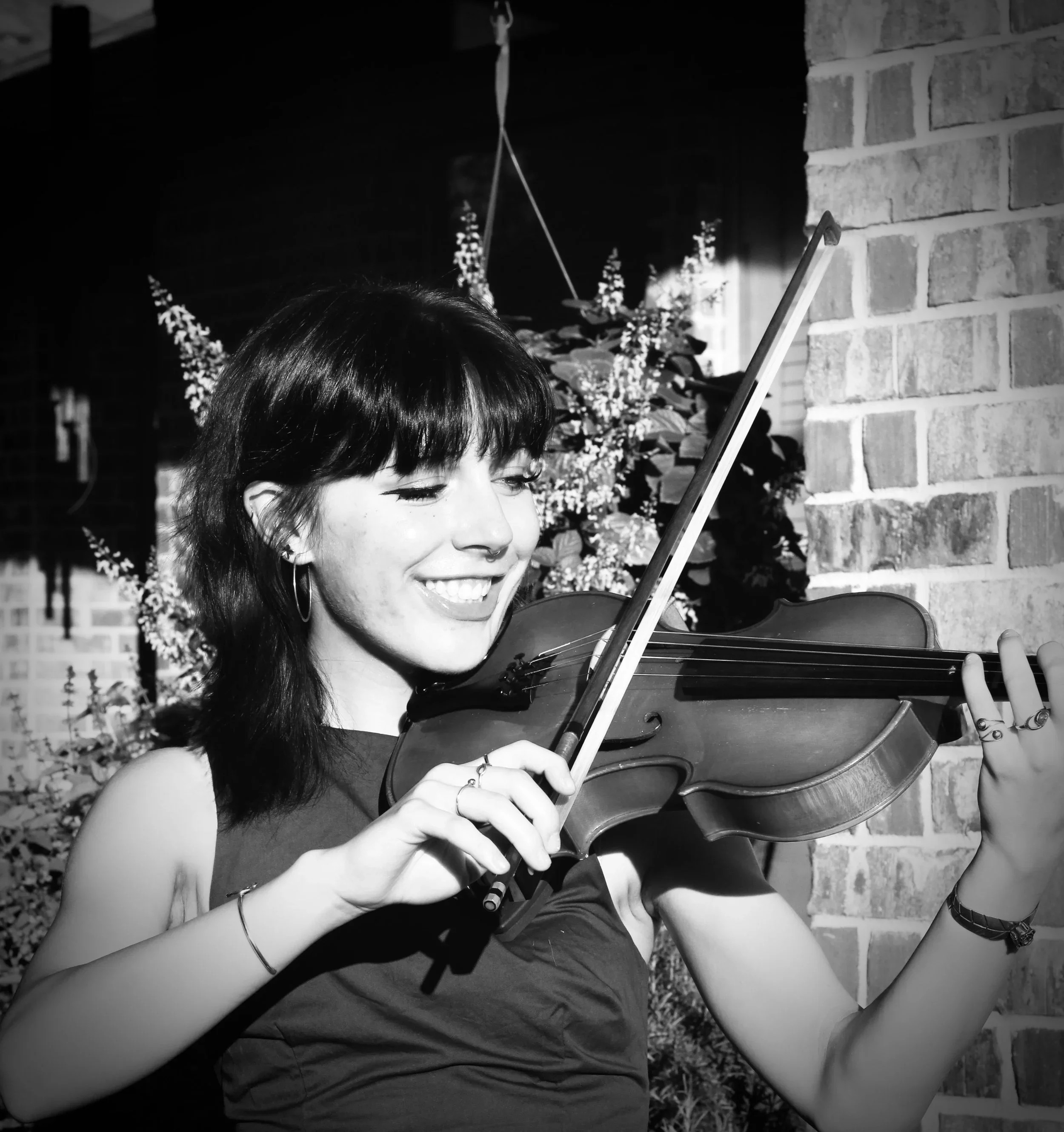 Lillian teaches piano, beginning guitar, and beginning violin at the Wylie School of Music. Pictured here with a violin.