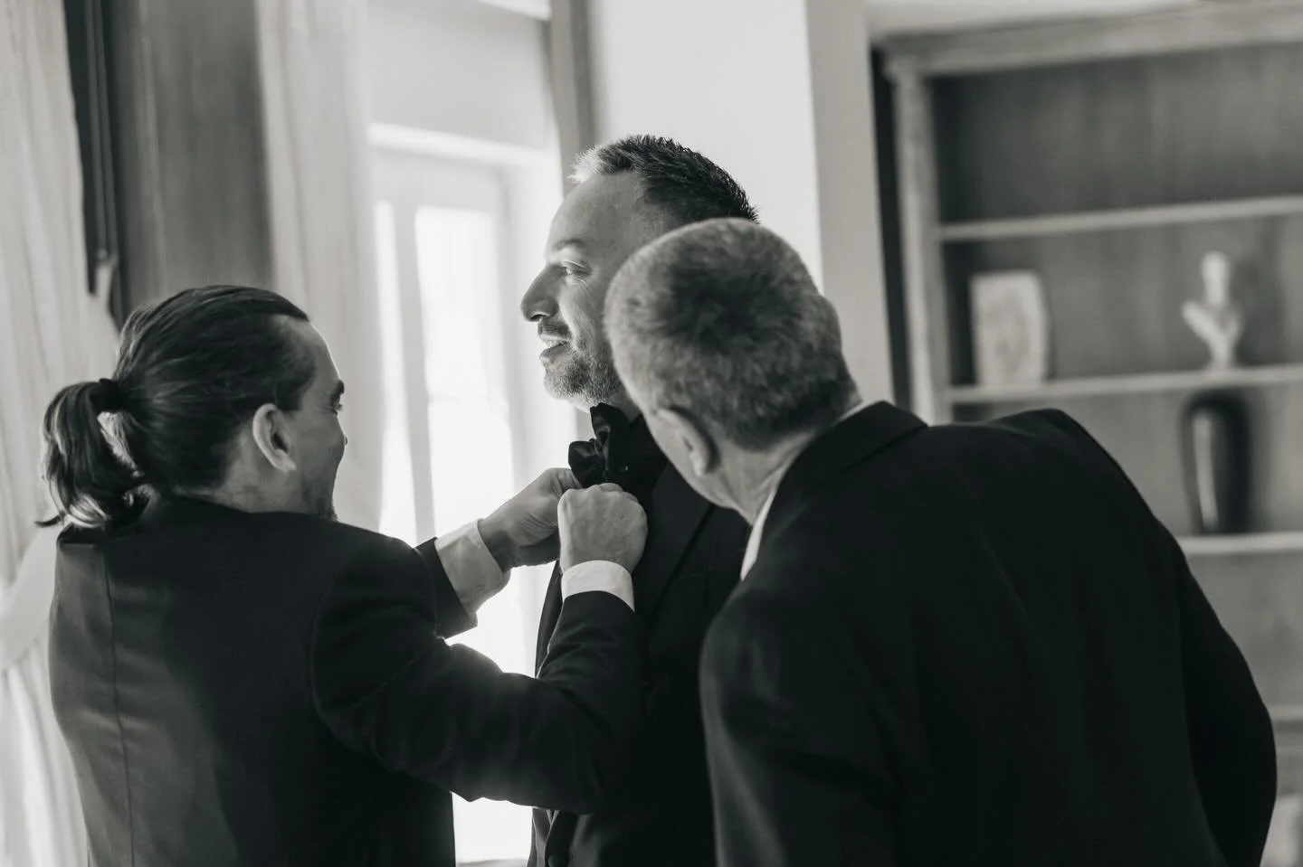 The art of getting ready - groom edition. 
Buttoned up with love and the people who matter the most, groom prep done right. 🤍

📸 Moment captured by @lifeclicks_studio at @santorini_gem.

#santoriniweddings #destinationweddings #weddingsingreece #ev
