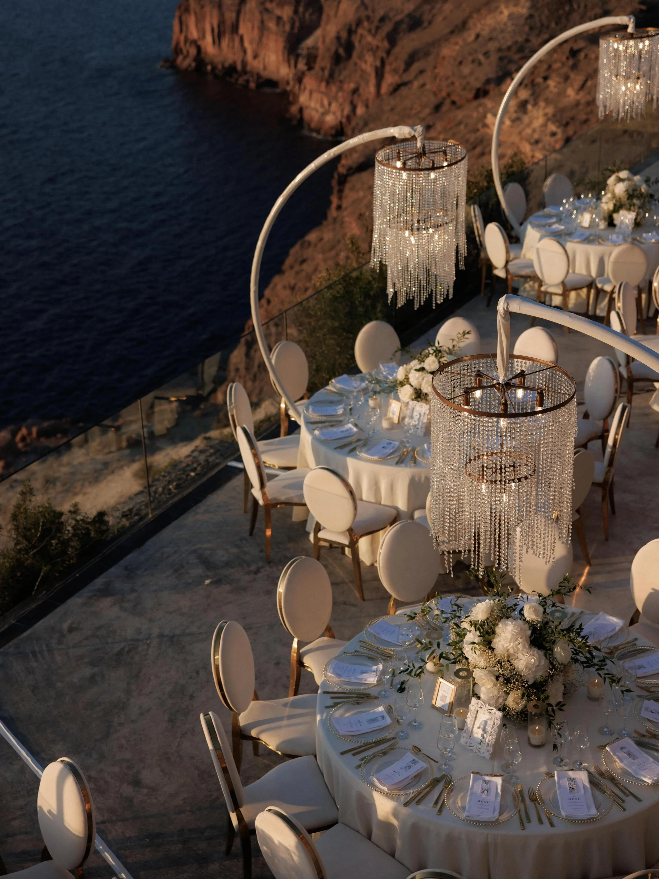 Designed to feel as breathtaking as the view itself. Crystal chandeliers, soft ivory textures and every detail layered with intention above the sea. ✨

Venue: @cavo_ventus_luxury_villa 
Photo - Video: @whiteonblackstudio 
Sound - Lights - Chandeliers