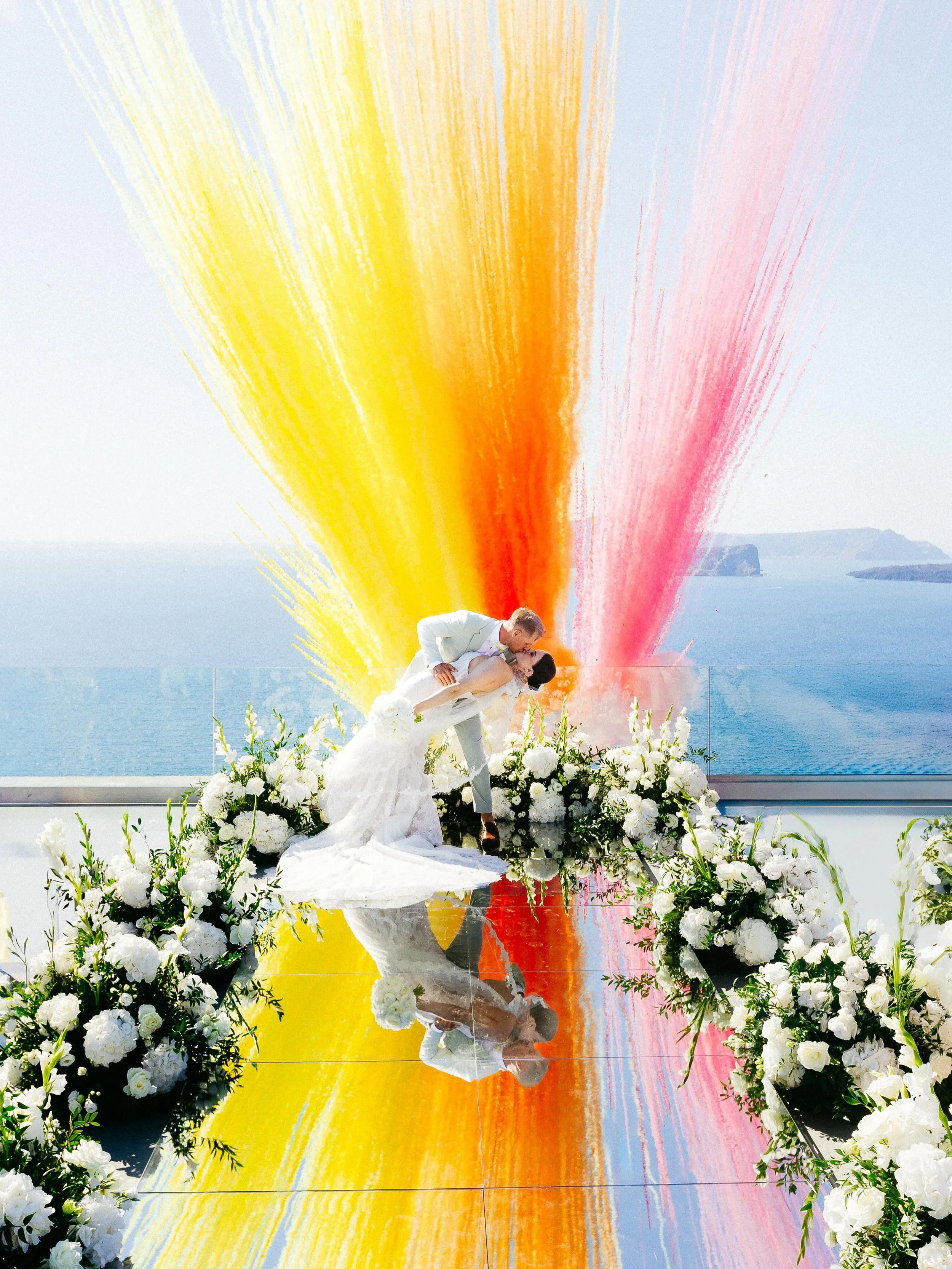 A kiss so powerful, it painted the sky. 🤍

Venue: @cavo_ventus_luxury_villa 
Photo &amp; Video: @kapetanakisstudios 
Mirror Aisle - Chandeliers - Sound - Light: @santorinievents 
Catering &amp; Equipment: @spicy_bites_catering_rentals 
Flowers: @sha