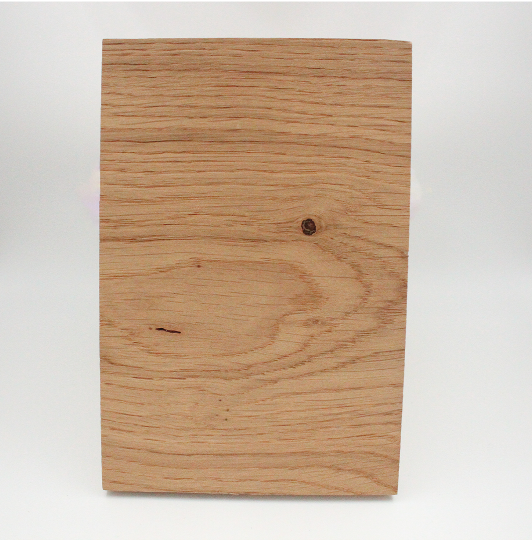 A piece of unfinished wood with visible grain and knots.