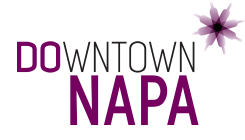 Logo for Downtown Napa featuring stylized grapevine or flower graphic with the words Downtown Napa in purple and black