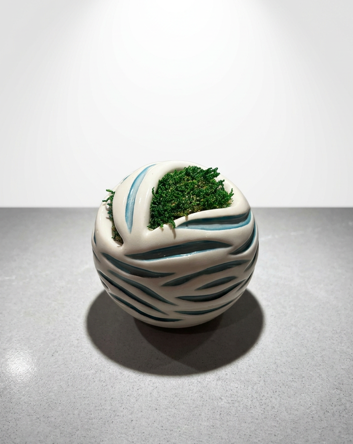 Ceramic clay sculpture with moss arrangement