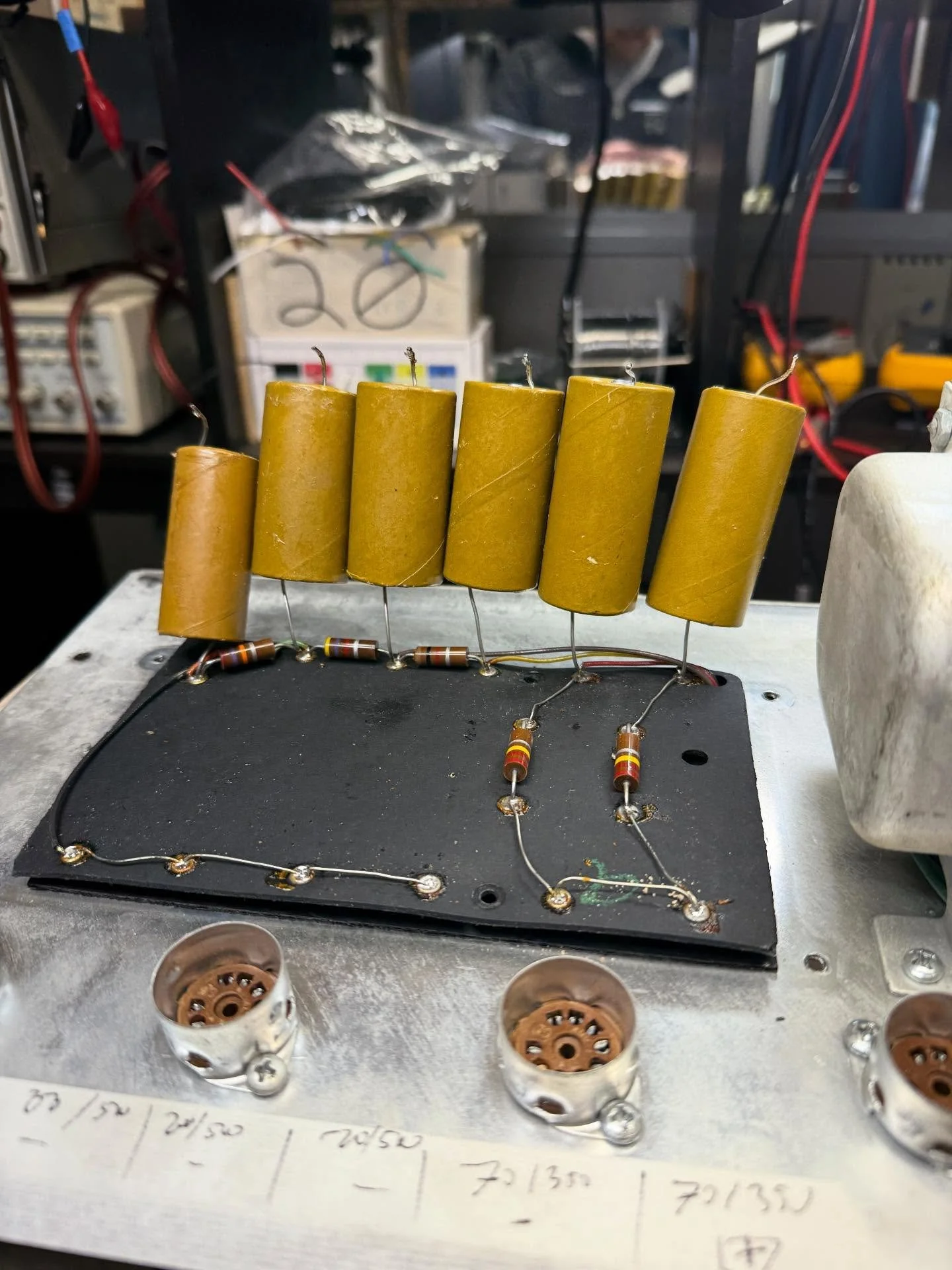 I told ChatGPT to make these filter caps into a rock band playing a gig. In introducing: The Capacitors! 🤣🎸🥁🤘