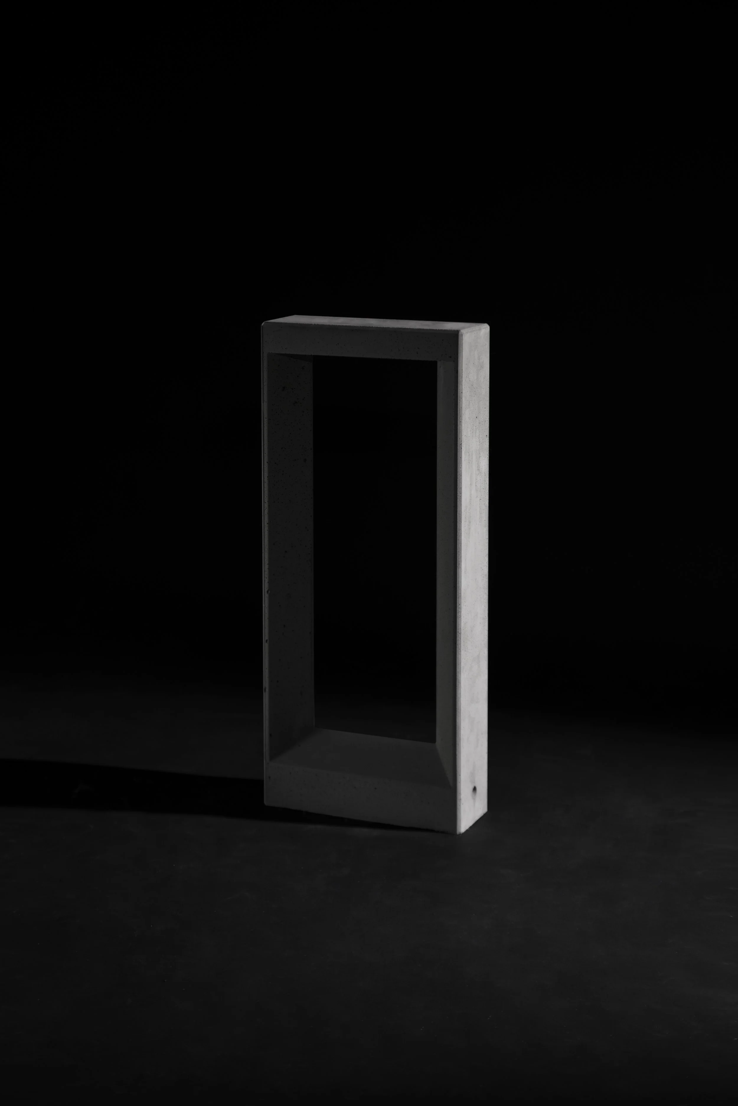 Concrete Frame Floor Lamp in front of a black background
