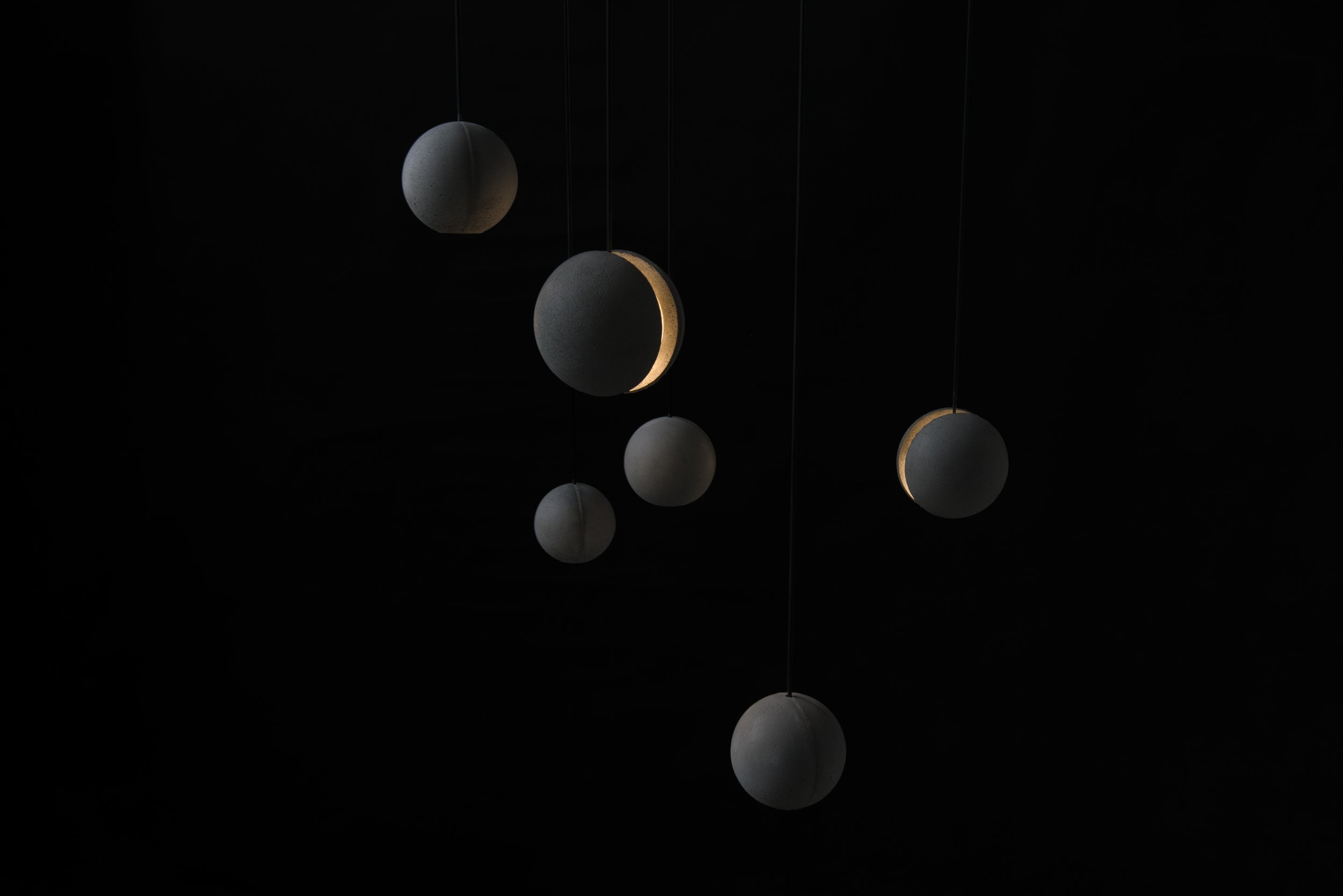 Concrete Moon Pendant Lights multiple hanging in a cluster light on