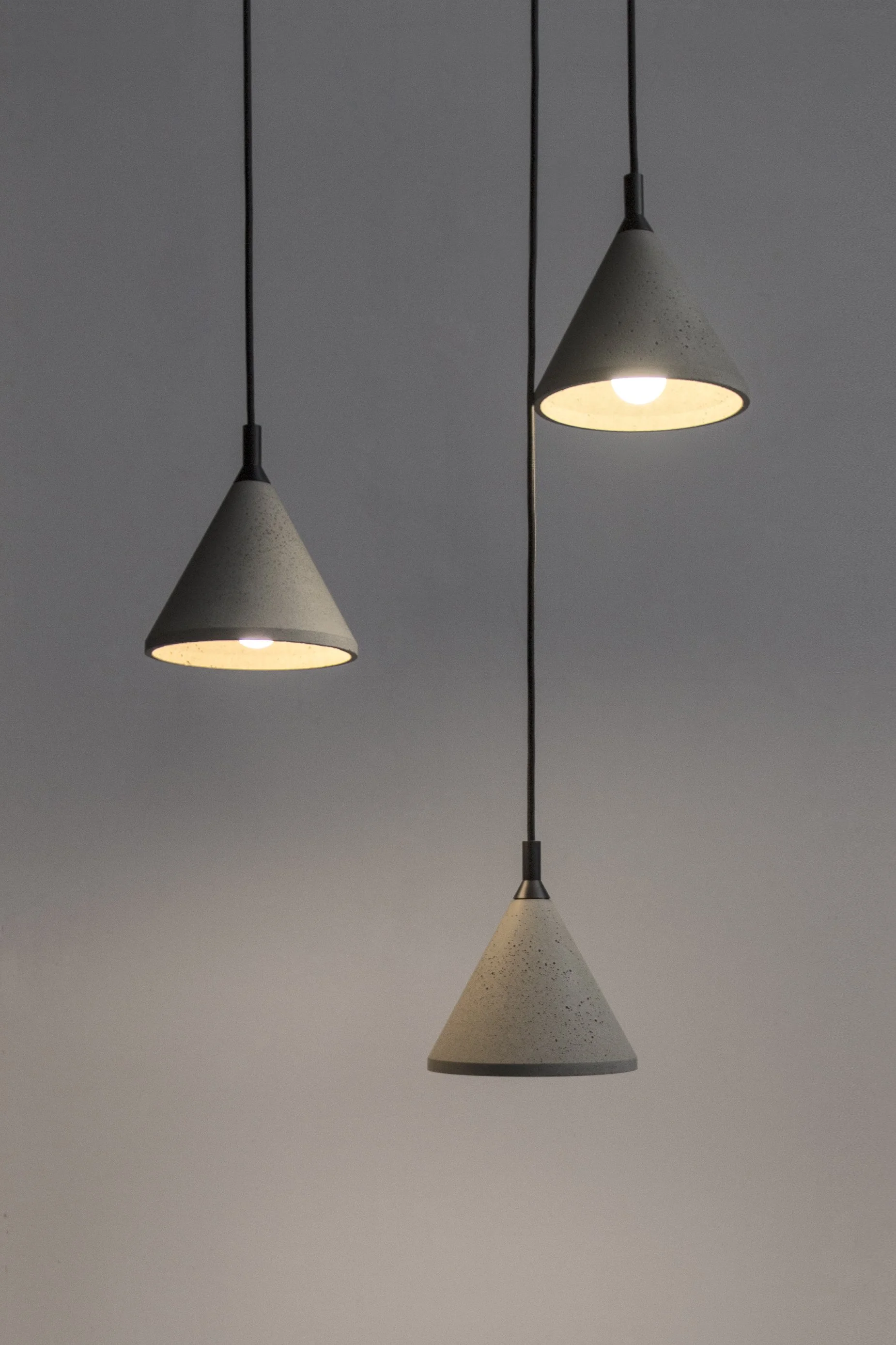 Three Cone Style Pendants Concrete Lights On Grey Background