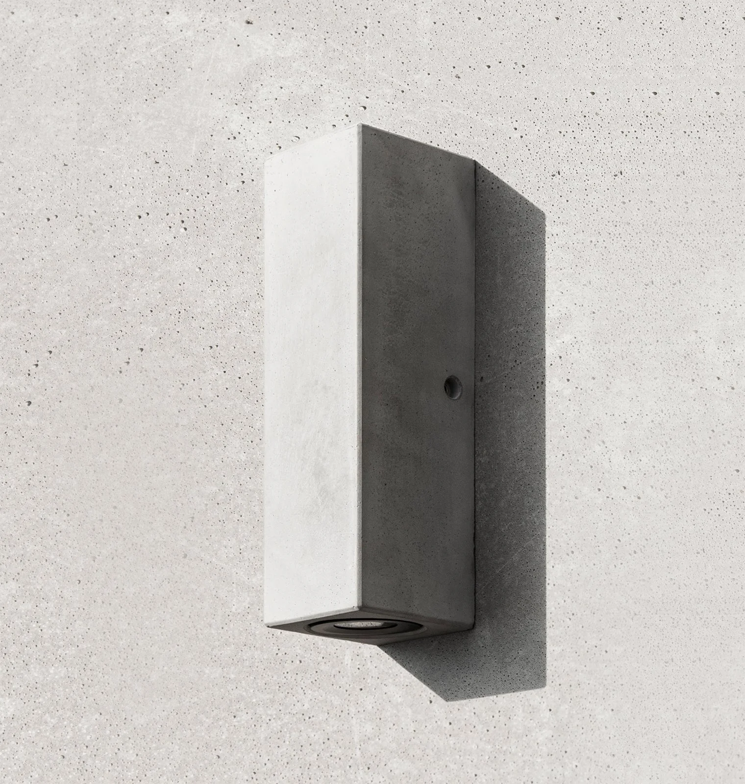 Outdoor Concrete Tall Rectangular Wall Sconce installed on a concrete wall in the sun