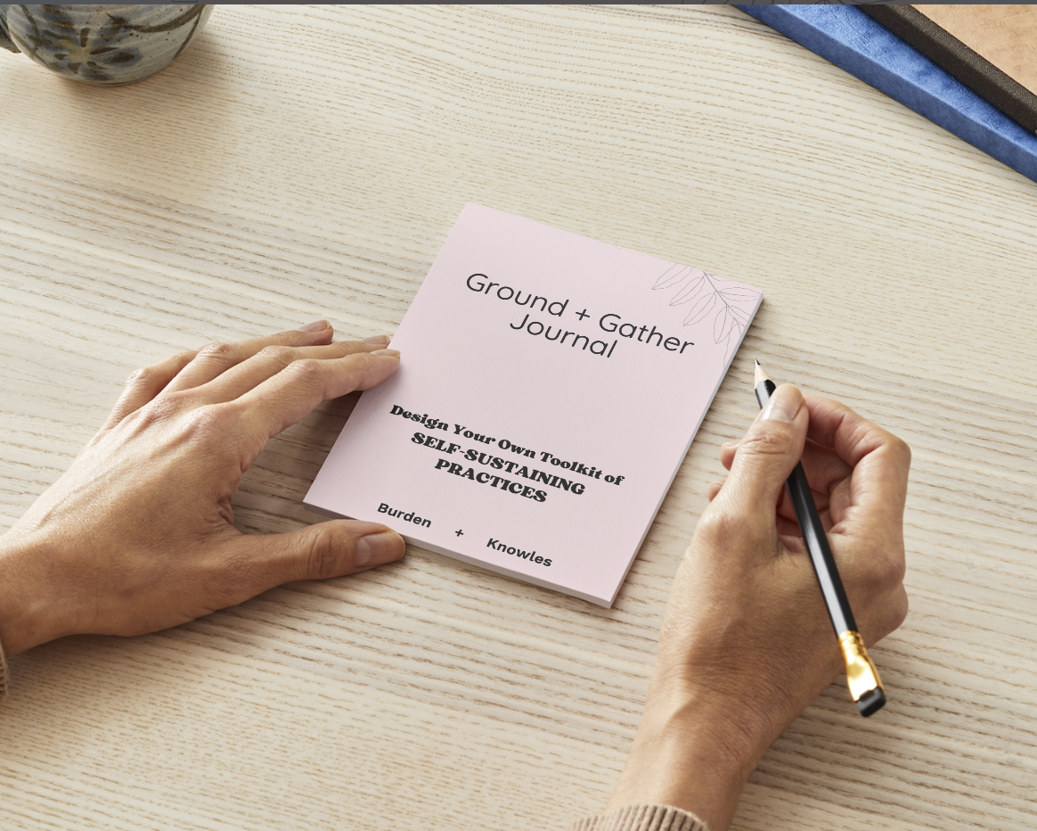Picture of the Ground and Gather journal sitting on a desk and pair of white hands getting ready to open it. The words "Design your Own Toolkit of Self Sustaining Practices" is on the front.