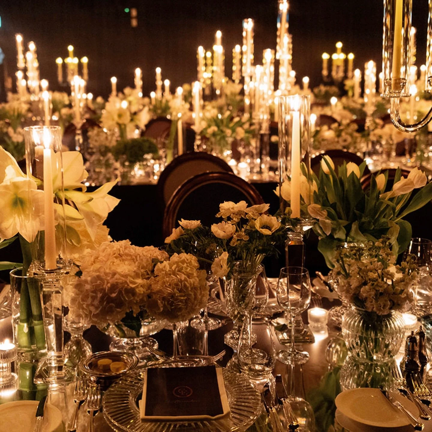 The dining room for C&amp;E was a real study in scale, symmetry, and light.
Layered candle heights, reflective surfaces, and restrained florals were intentionally composed to create depth without excess&mdash;allowing the tablescape to feel immersive