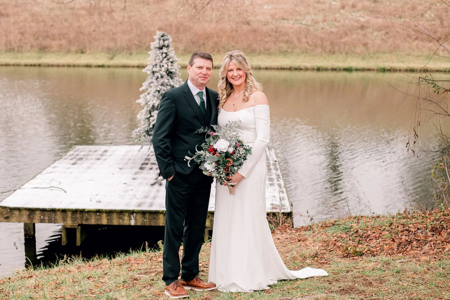 dock on pond christmas tree portraits with bride and groom