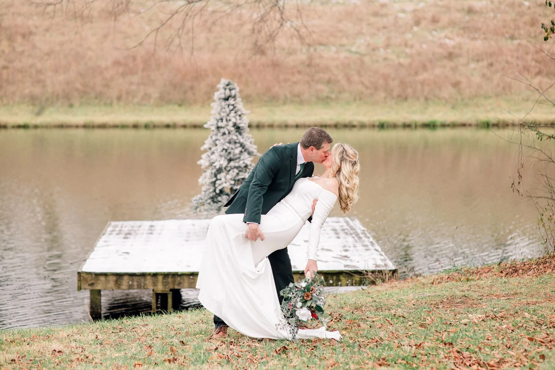 Bride and groom portraits at dock on pond at Della Mae Luxury Weddings Events