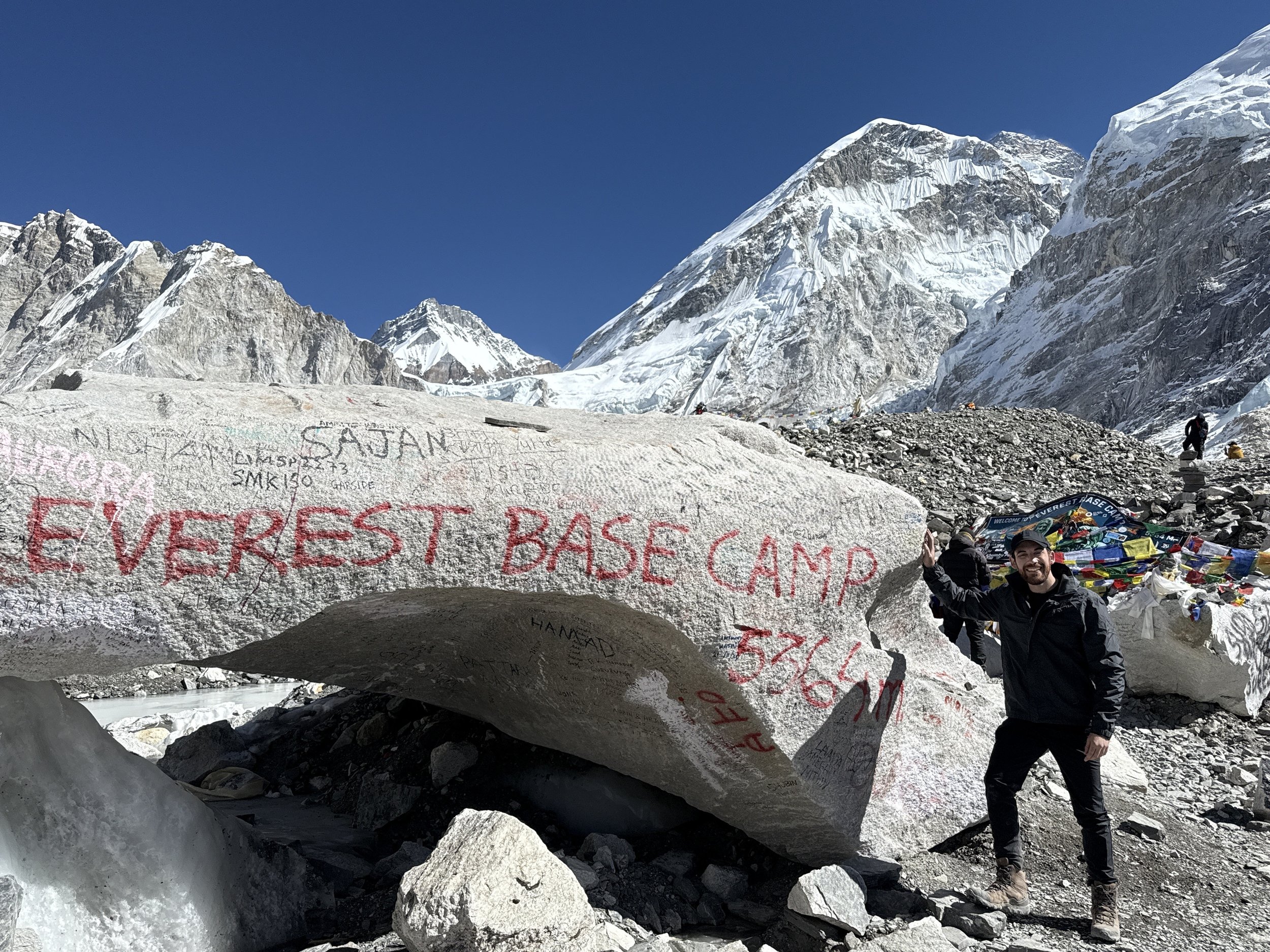 The emotional arrival at Everest Base Camp rock—the symbolic goal of the trek.