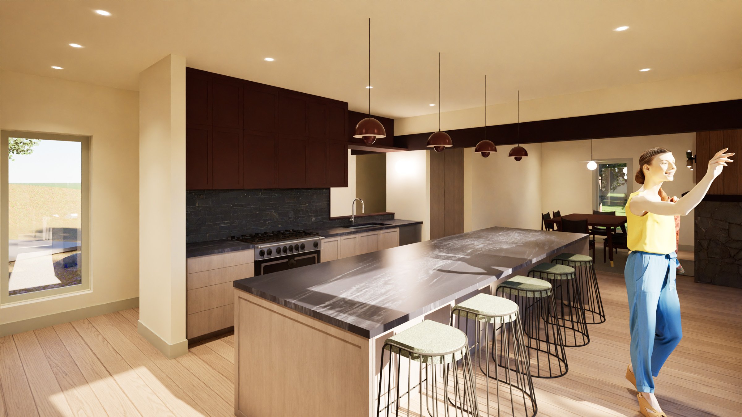 Modern kitchen with a large island, bar stools, dark upper cabinets, light lower cabinets, and a person with long hair, wearing a yellow top and blue pants in a new construction cabin / lake house in the Brainerd Lakes Area MN.