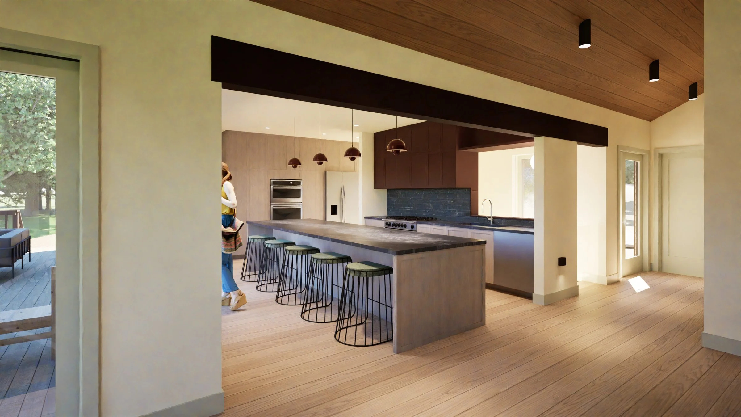 Modern kitchen with light wood cabinets, a large island with bar stools, black pendant lights, and a view of a backyard outdoor patio in a new construction cabin / lake house in the Brainerd Lakes Area, MN.